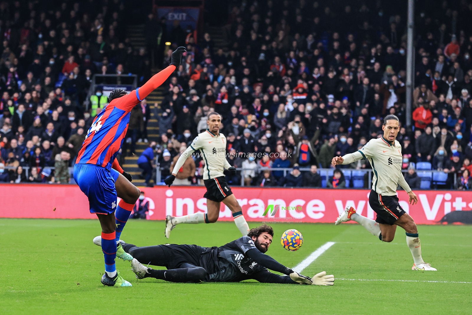 Alisson Becker #1 of Liverpool puts Jean-Philippe Mateta #14 of Crystal Palace's shot out for a corner