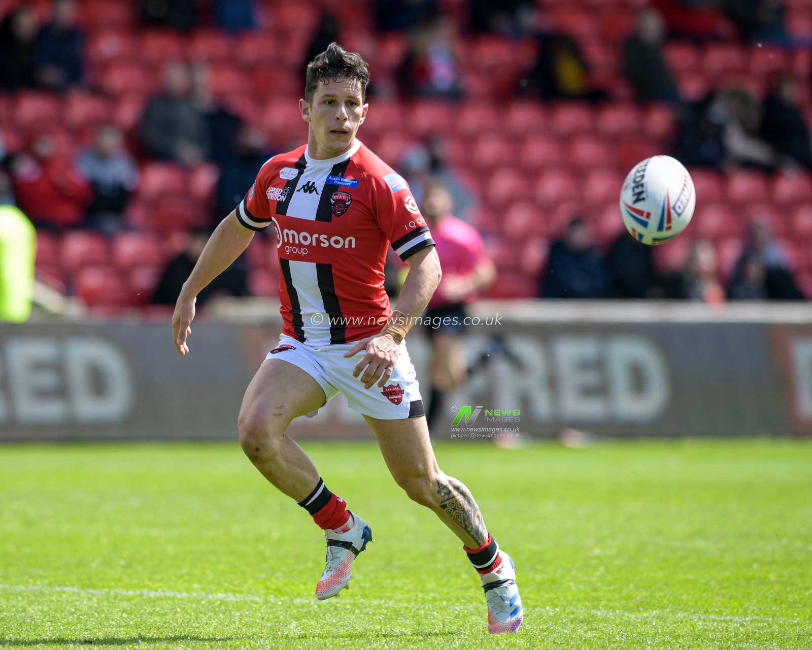 Morgan Escare (1) of Salford Red Devils chases the ball