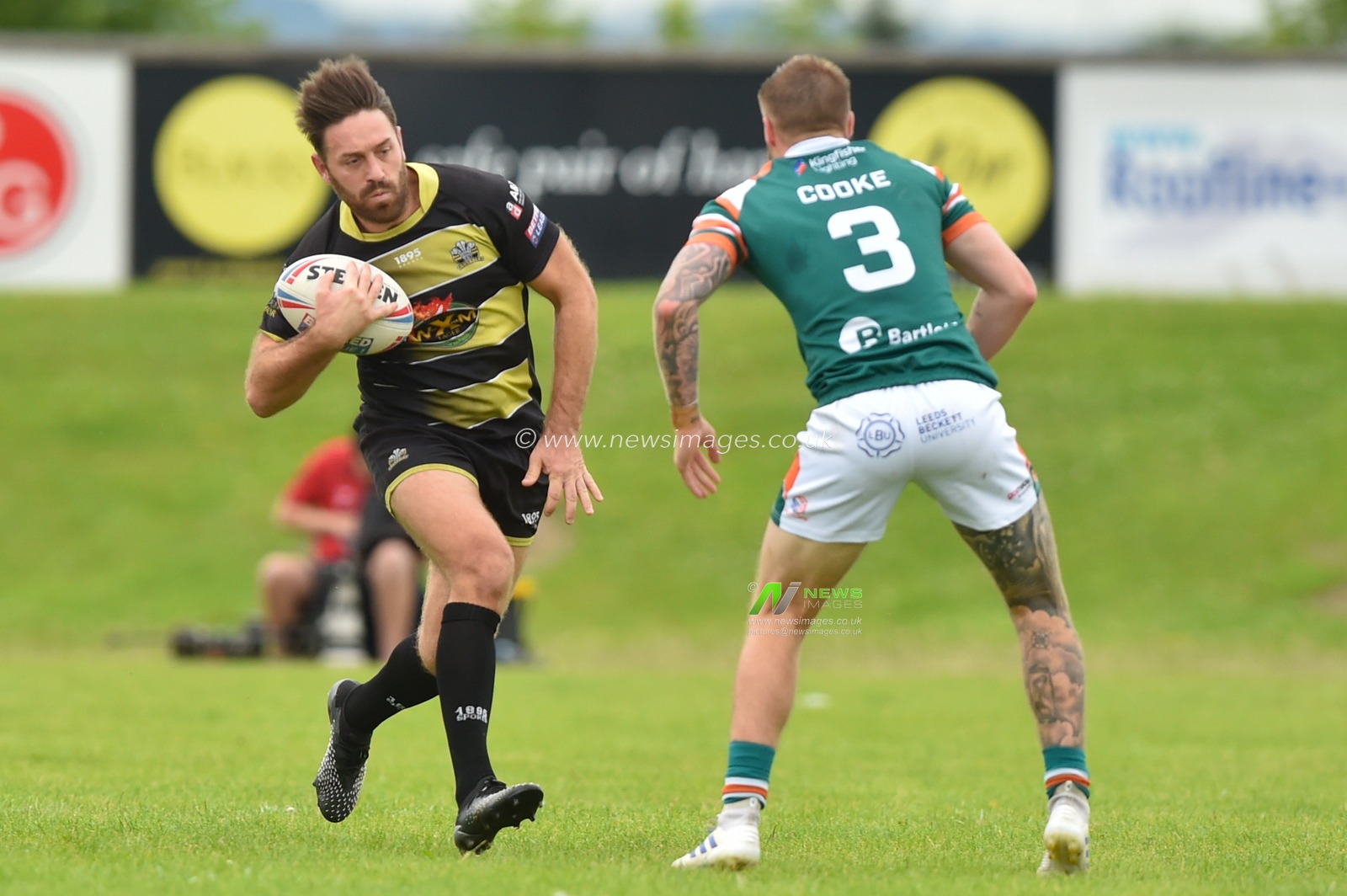 Tommy Johnson of North Wales Crusaders ahead of Will Cooke (3) of Hunslet RLFC