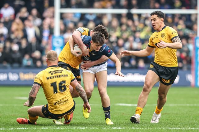 George Brown of Leeds Rhinos is tackled by Daejarn Asi of Castleford Tigers and Joe Stimson of Castleford Tigers during the Betfred Super League round 4 match Leeds Rhinos vs Castleford Tigers at AMT Headingley Stadium, Leeds, United Kingdom on 08 March 2026

(Photo by Alfie Cosgrove/News Images)