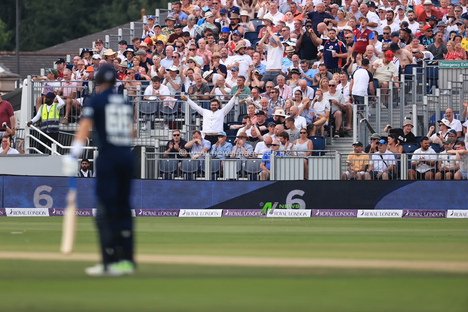 A England fan signals a six after Joe Root of England hits a peach of a six