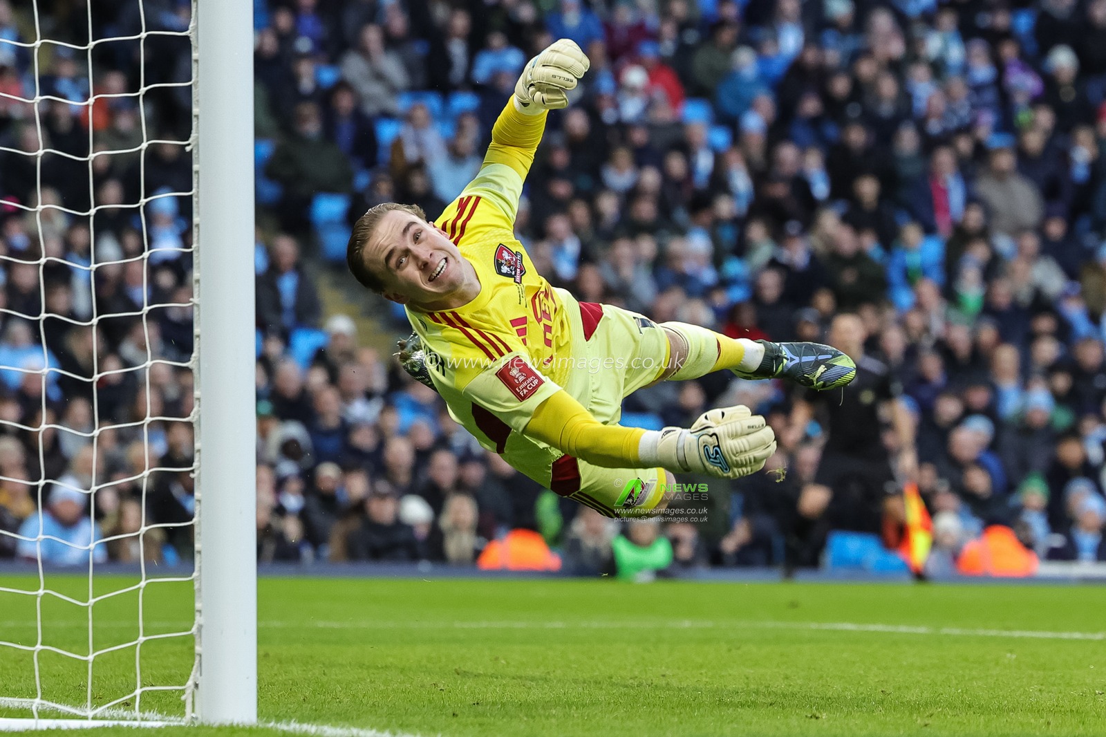 Exeter City goalkeeper Joe Whitworth dives the the ball and fails to stop Rodrigo of Manchester City’s goal during the Emirates FA Cup Third Round match Manchester City vs Exeter City at Etihad Stadium, Manchester, United Kingdom, 10th January 2026

(Photo by Mark Cosgrove/News Images)