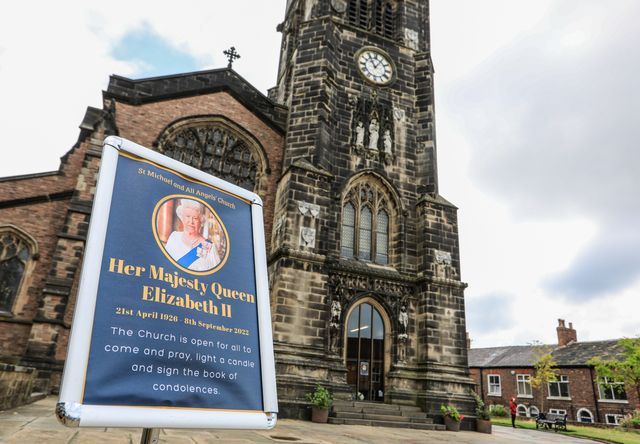 A sign of the Queen is on display outside St Michael and All Angels Church, Macclesfield