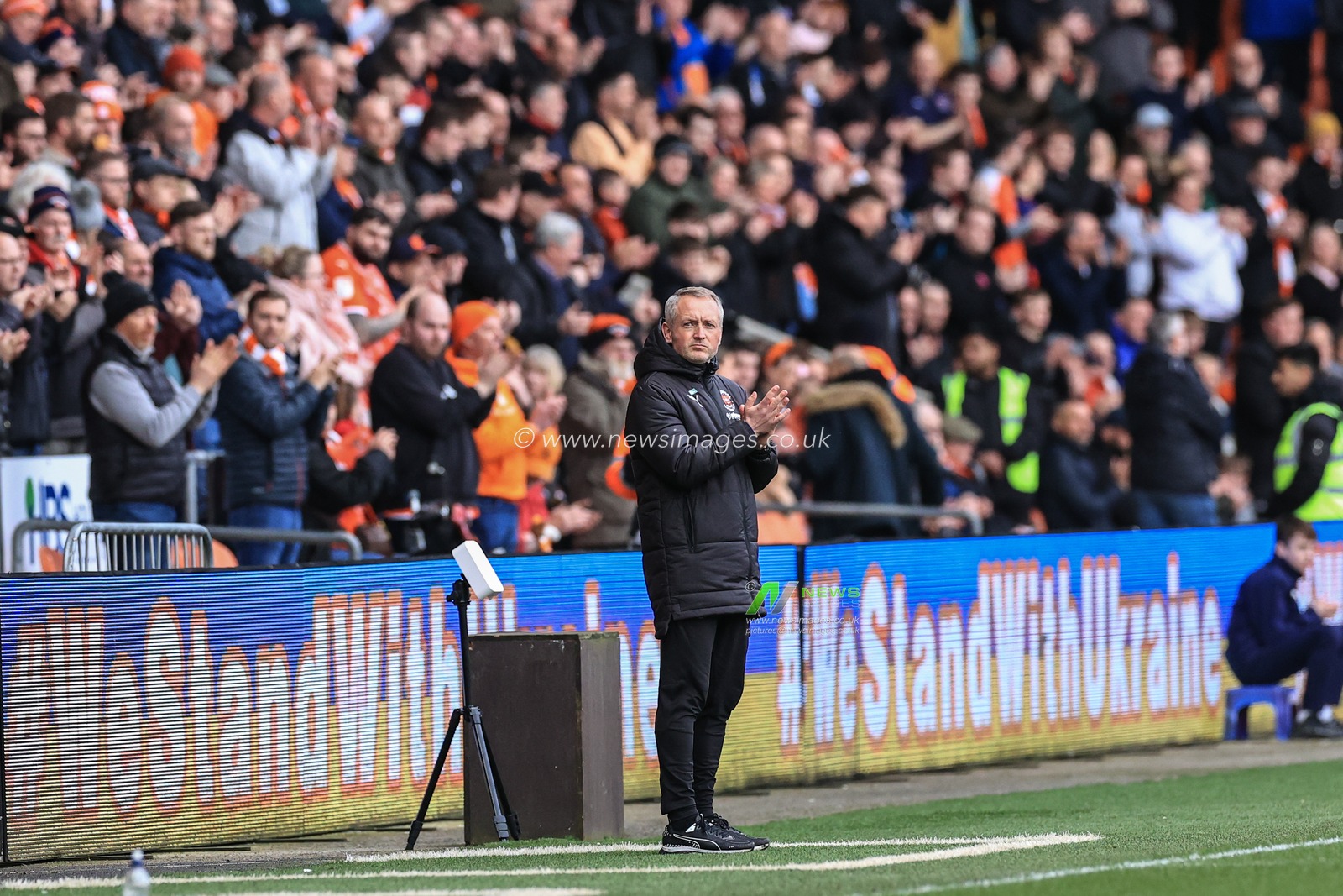 Neil Critchley head coach of Blackpool applauds to say we stand with the Ukraine