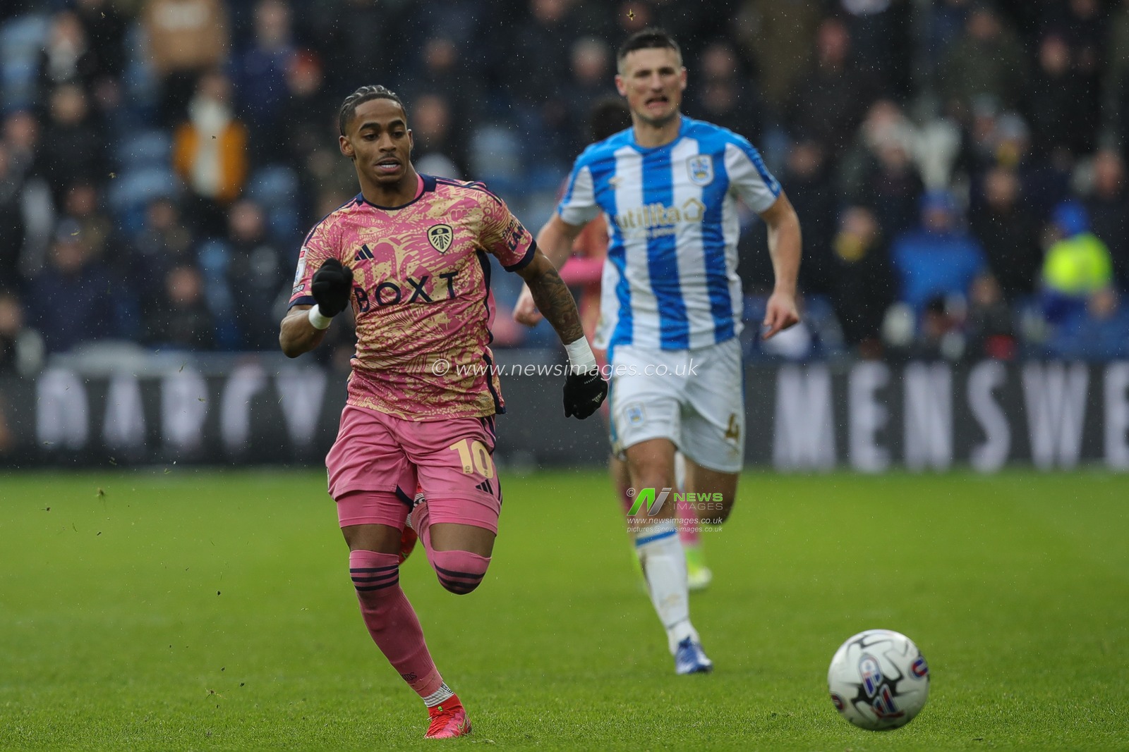 Crysencio Summerville of Leeds United gets away from Matty Pearson of Huddersfield Town during the Sky Bet Championship match Huddersfield Town vs Leeds United at John Smith's Stadium, Huddersfield, United Kingdom, 2nd March 2024

(Photo by James Heaton/News Images)