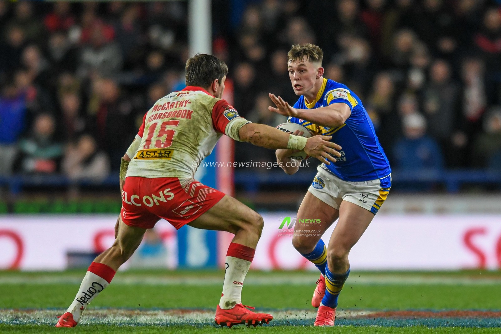 Jack Broadbent #23 of Leeds Rhinos looks for a way past Louie McCarthy-Scarsbrook #15 of St Helens