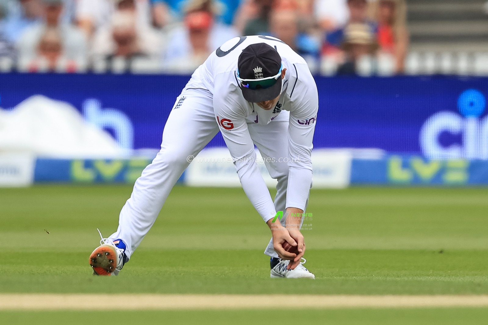 Ollie Pope of England collects the ball