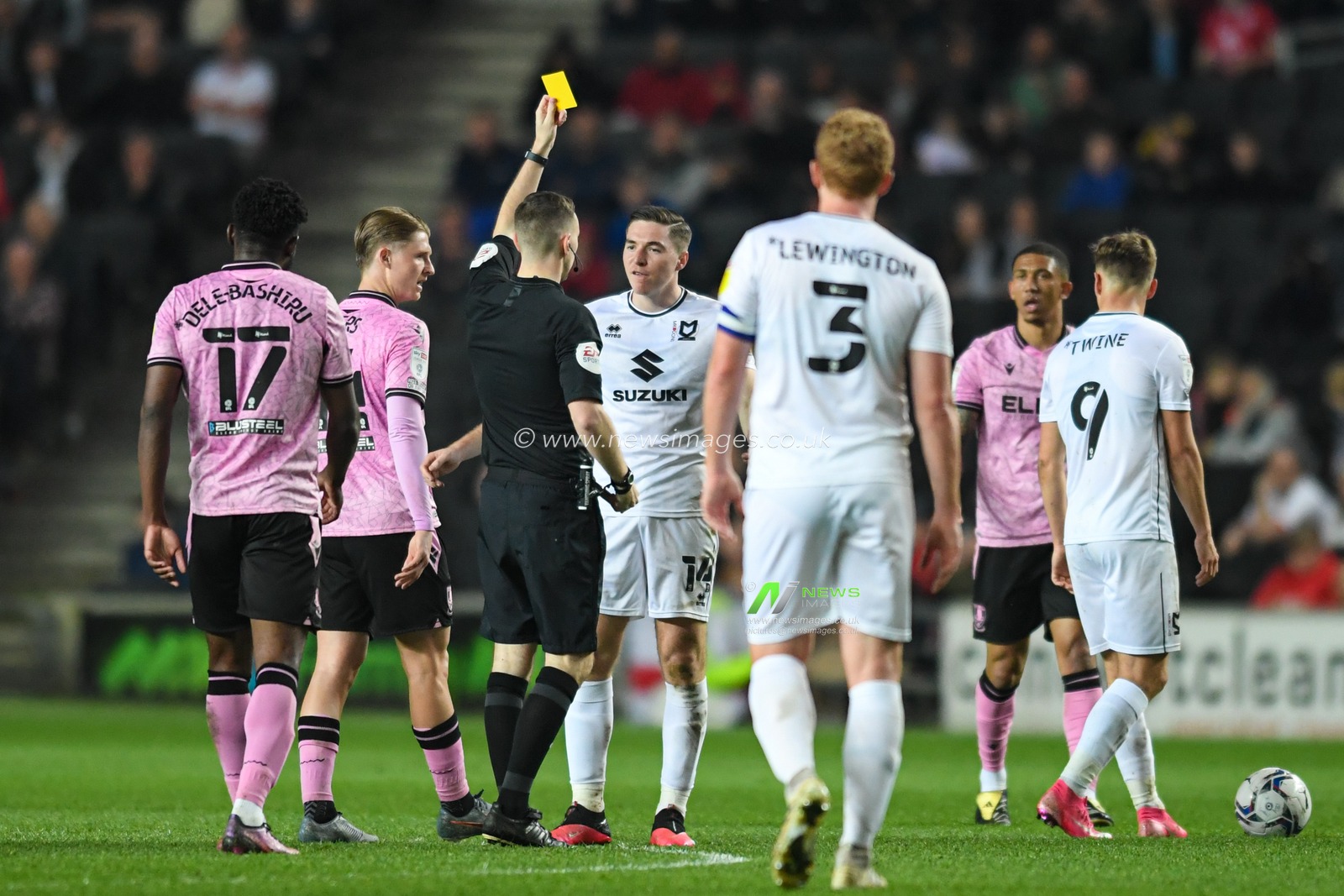 Conor Coventry #14 of Milton Keynes Dons is shown a yellow card