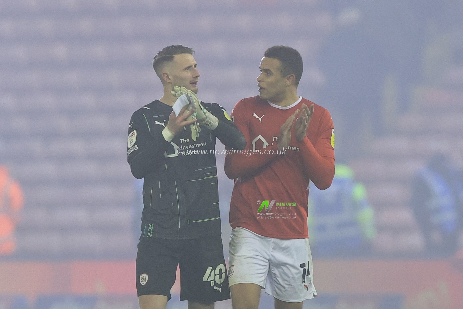 Bradley Collins #40 of Barnsley and Carlton Morris #14 of Barnsley applaud the home fans