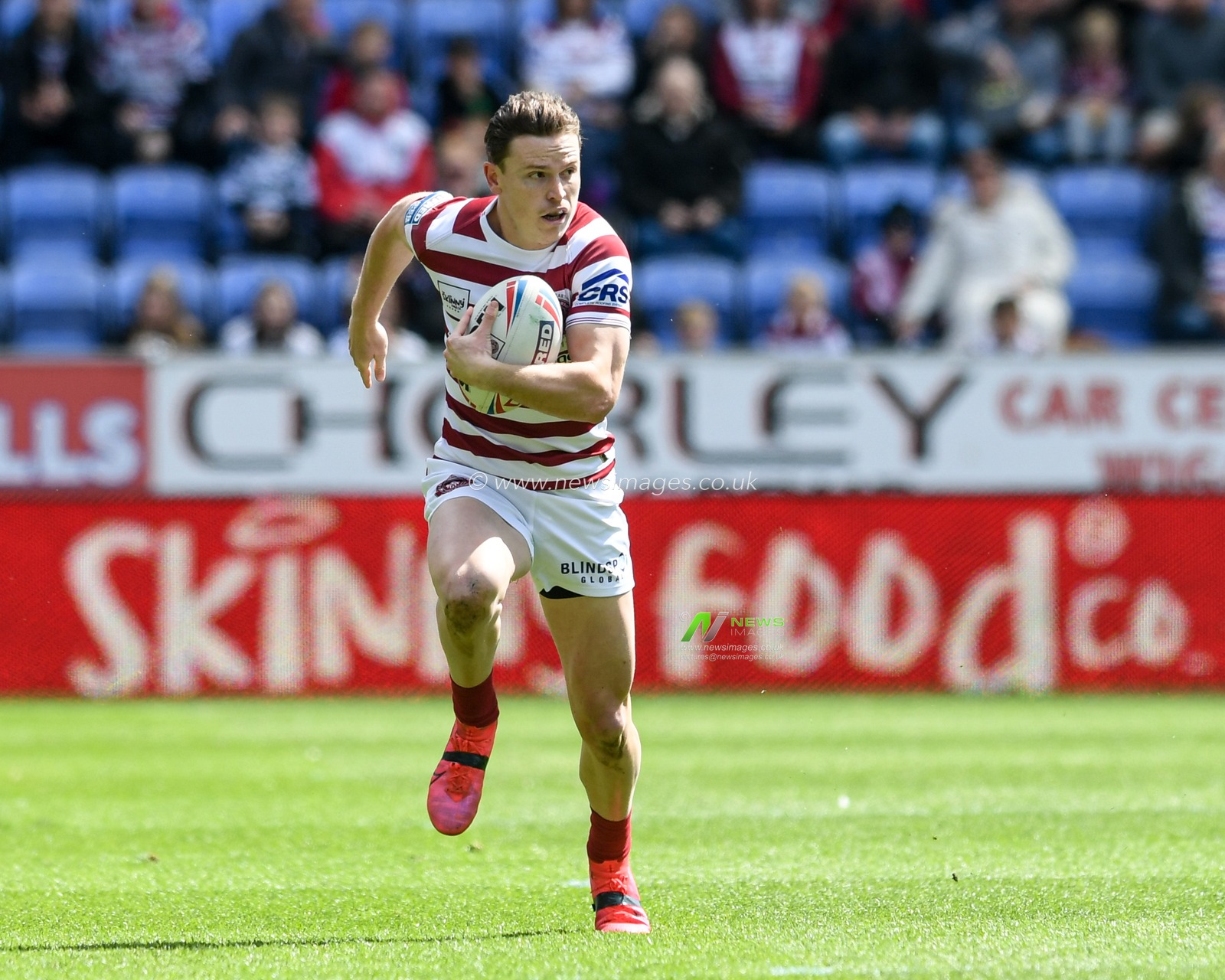 Jai Field #23 of Wigan Warriors runs forward with the ball