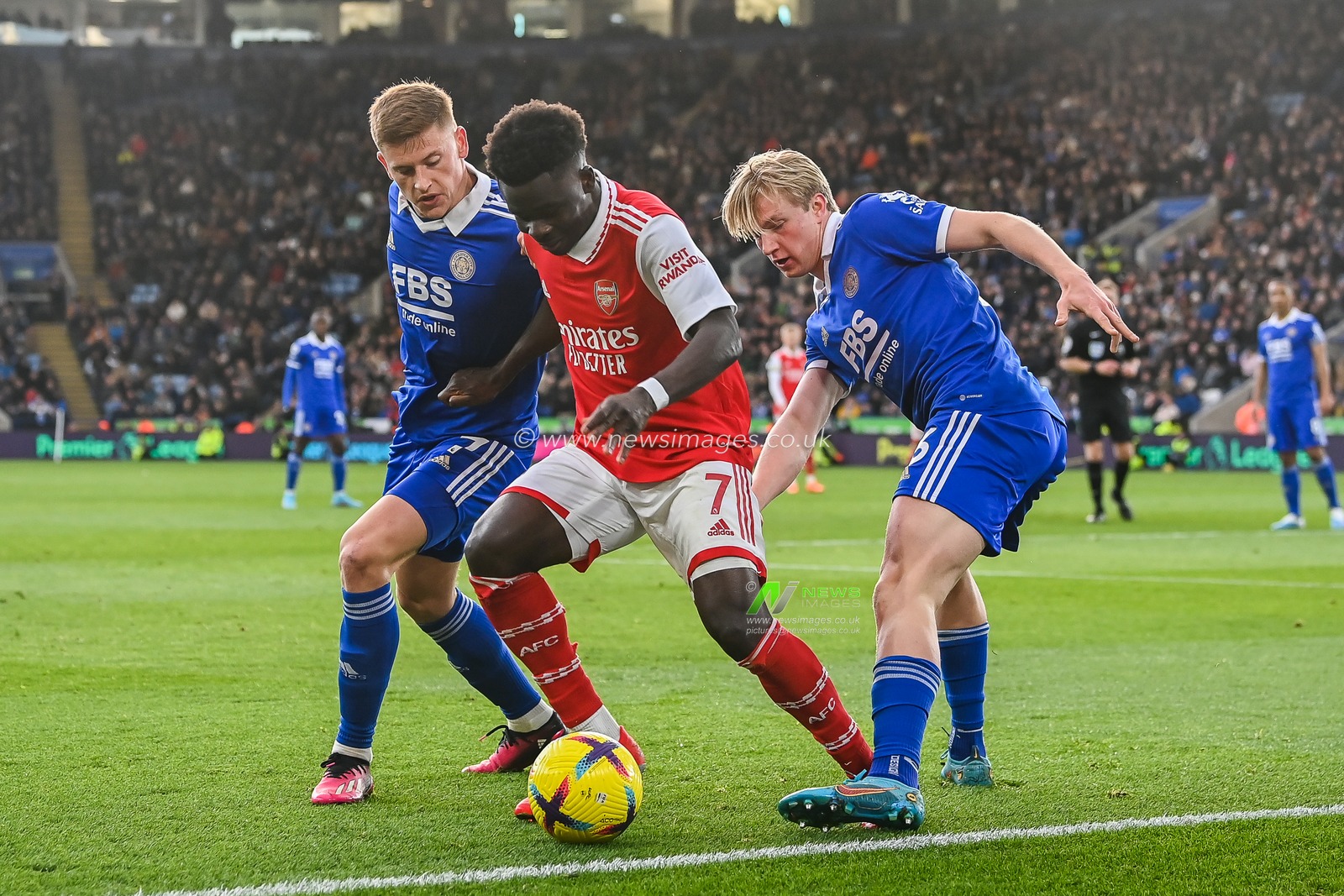 Bukayo Saka #7 of Arsenal holds off Harvey Barnes #7 and Victor Kristiansen #16 of Leicester City during the Premier League match Leicester City vs Arsenal at King Power Stadium, Leicester, United Kingdom, 25th February 2023

(Photo by Craig Thomas/News Images)