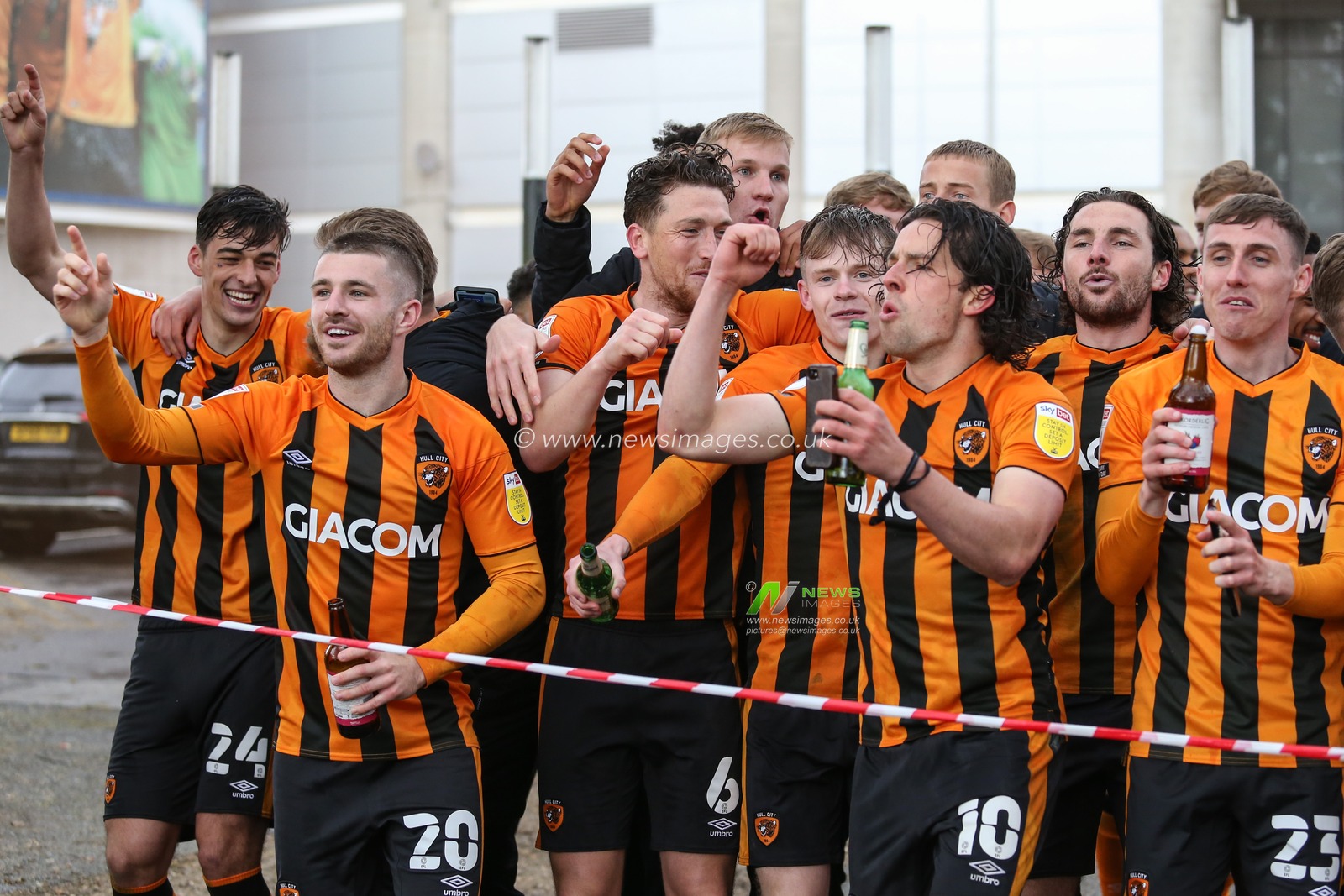 Hull City players celebrate outside the KCOM Stadium in front of the waiting fans