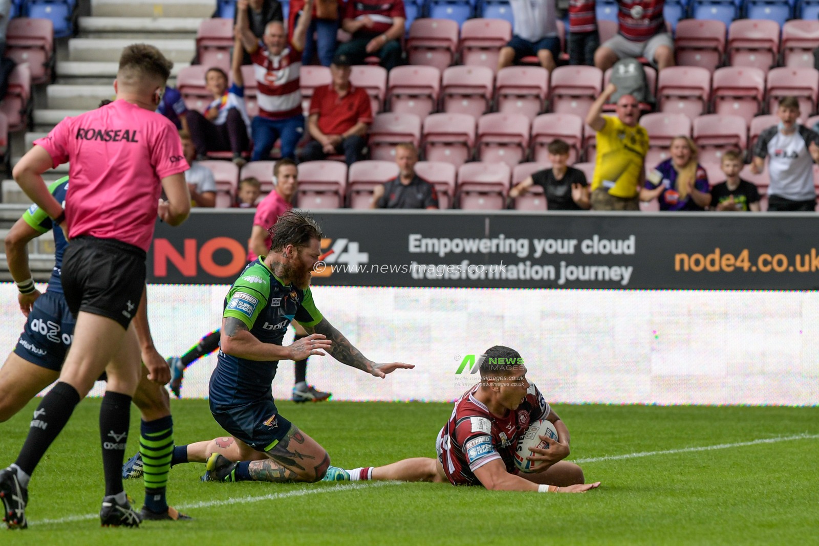Mitch Clark (23) of Wigan Warriors goes over for a try to make it 10-12
