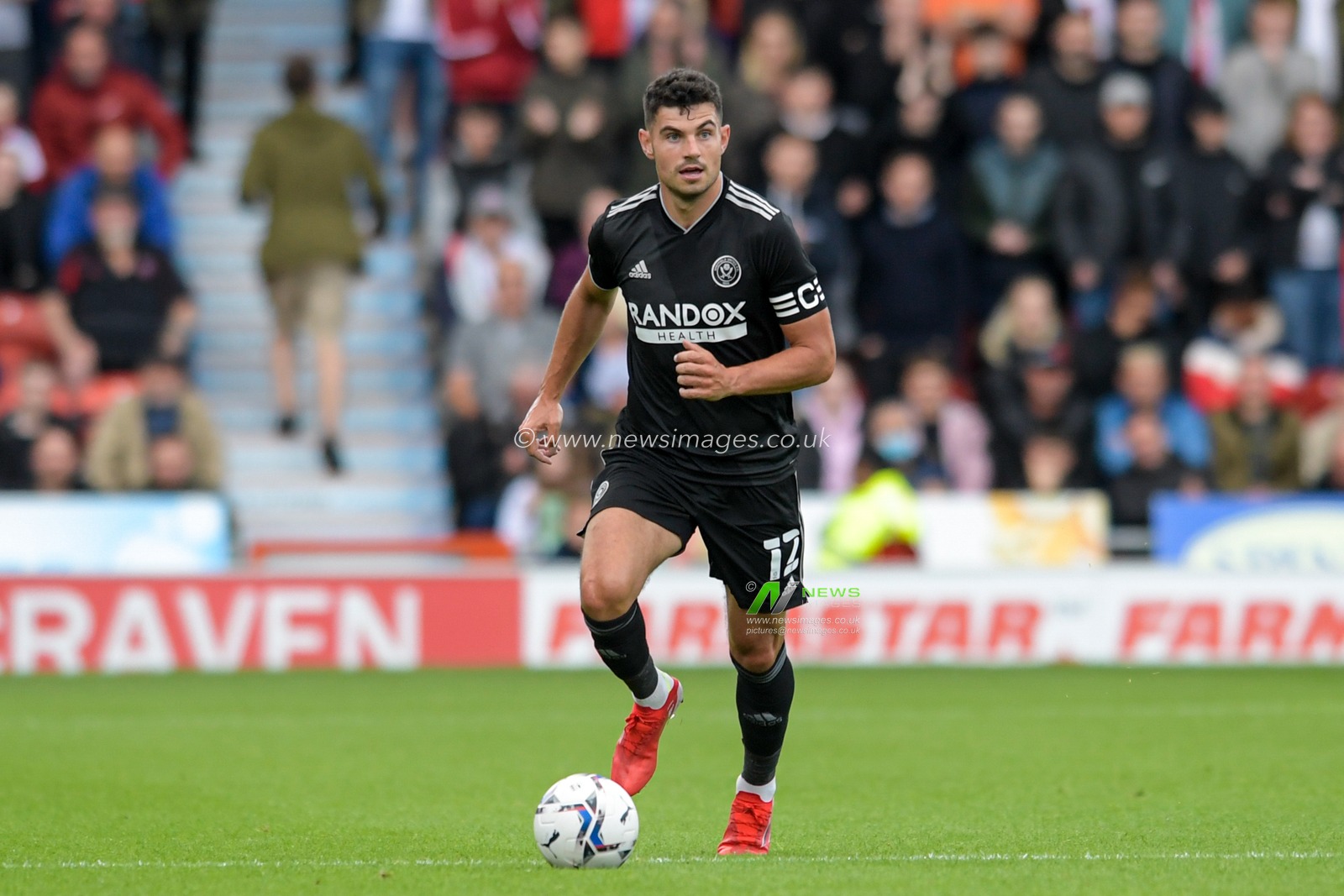 John Egan #12 of Sheffield United runs forward with the ball