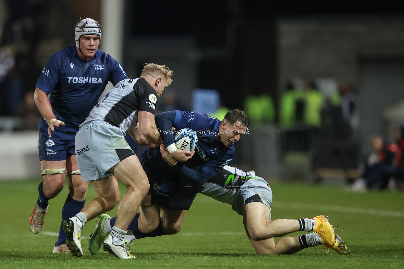 Tom Roebuck of Sale Sharks is tackled by Cameron Hutchison of Newcastle Falcons and Adam Radwan of Newcastle Falcons during the Gallagher Premiership match Sale Sharks vs Newcastle Falcons at Salford Community Stadium, Eccles, United Kingdom, 11th October 2024

(Photo by Alfie Cosgrove/News Images)