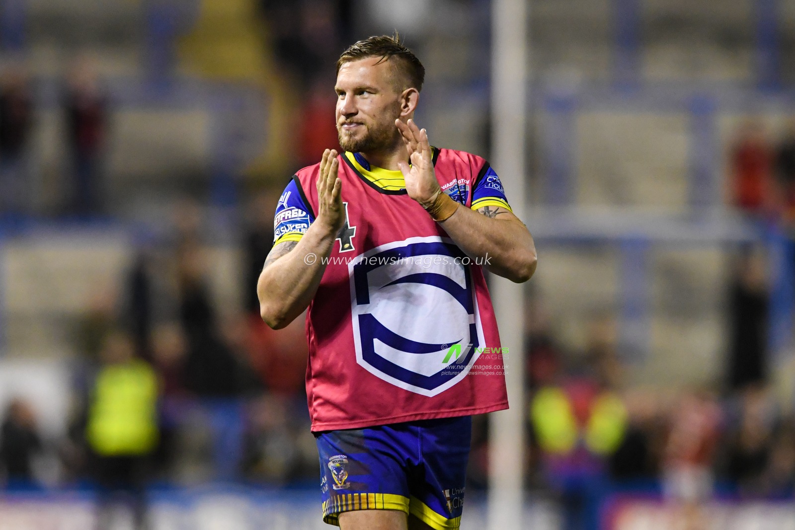 Mike Cooper #10 of Warrington Wolves applauds the home supporters at the end of the game after his side beat Salford Red Devils 32-18