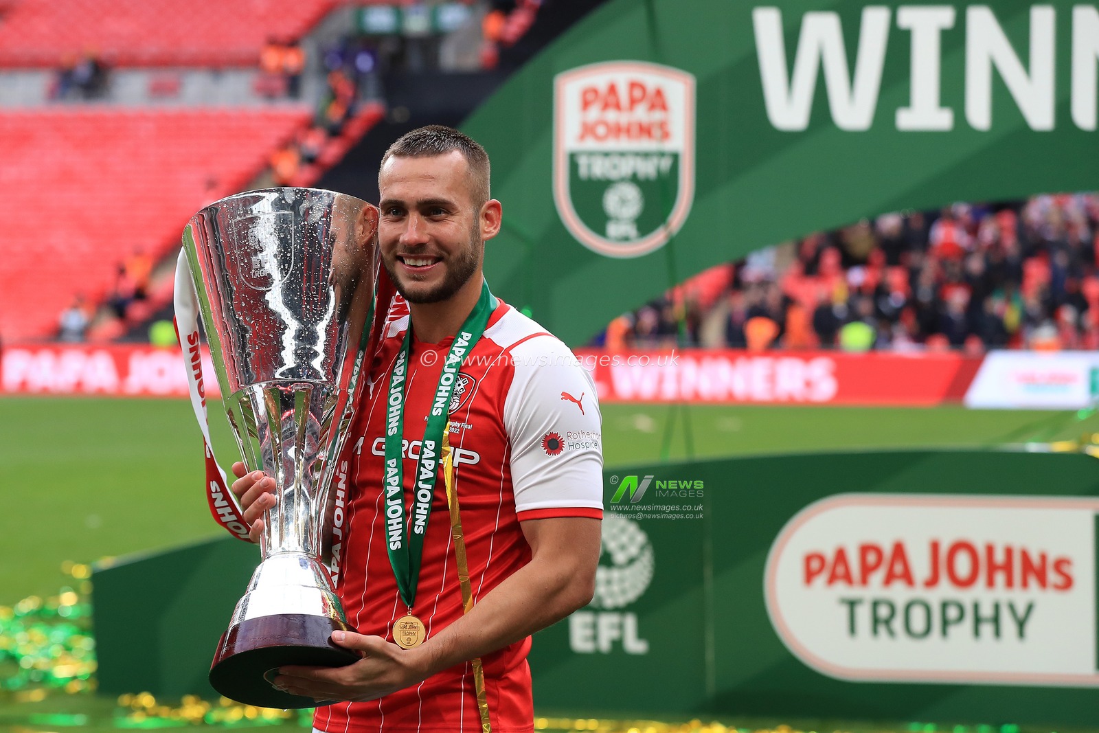 Joe Mattock #3 of Rotherham United with the trophy.