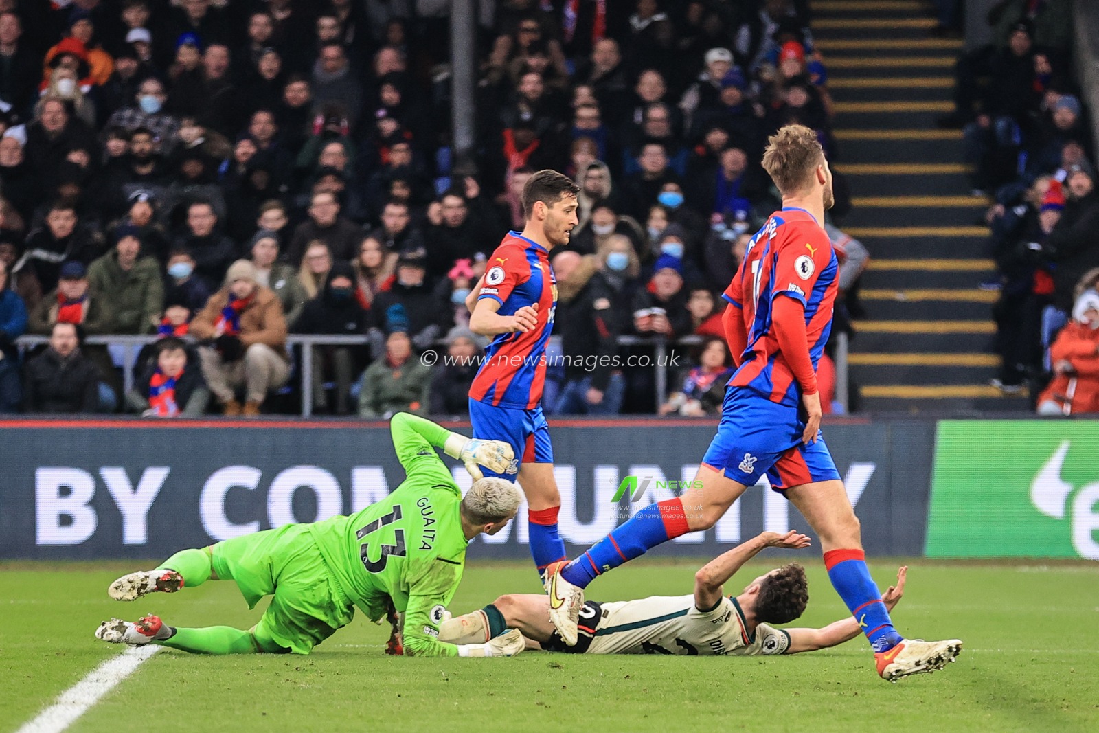 Vicente Guaita #13 of Crystal Palace brings Diogo Jota #20 of Liverpool down for a penalty