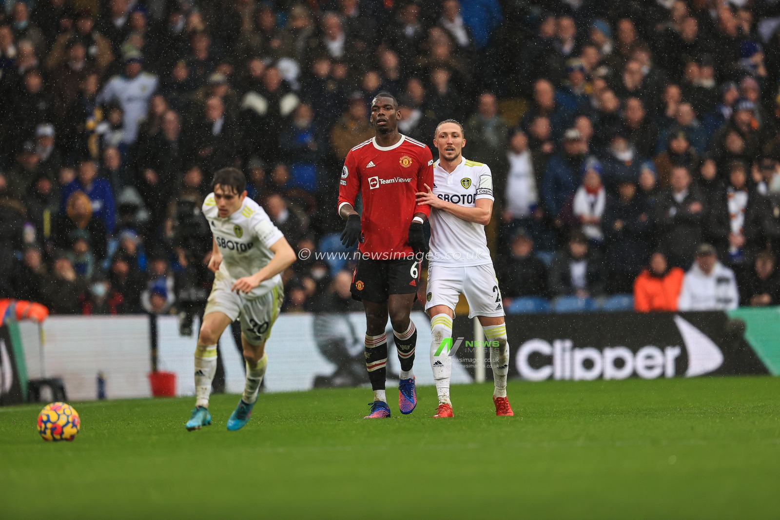 Luke Ayling #2 of Leeds United holds offPaul Pogba #6 of Manchester United