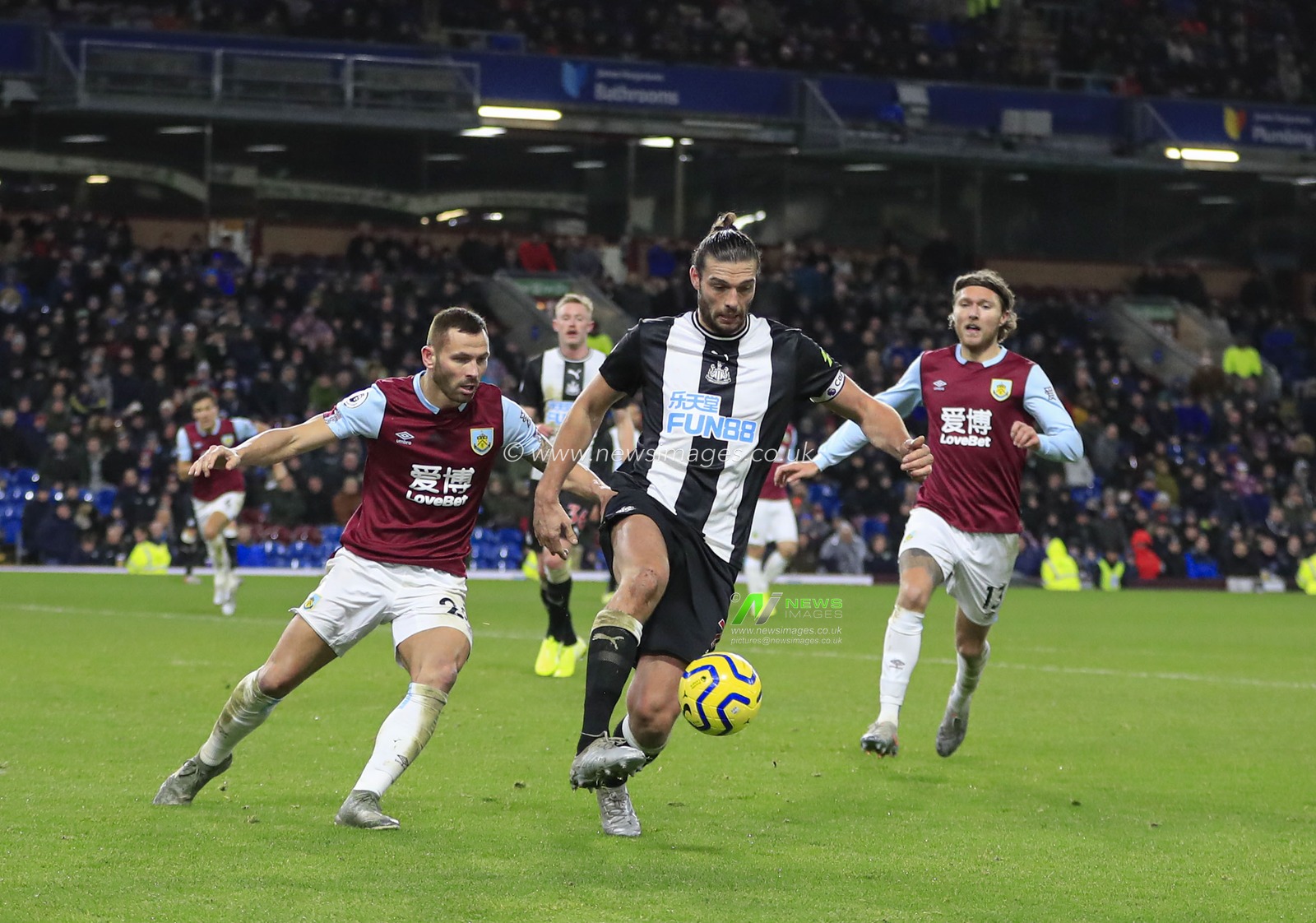 14th December 2019, Turf Moor, Burnley, England; Premier League, Burnley v Newcastle United : Andy Carroll (7) of Newcastle United controls the ball under challenge from Phillip Bardsley (26) of Burnley 

Credit: Conor Molloy/News Images