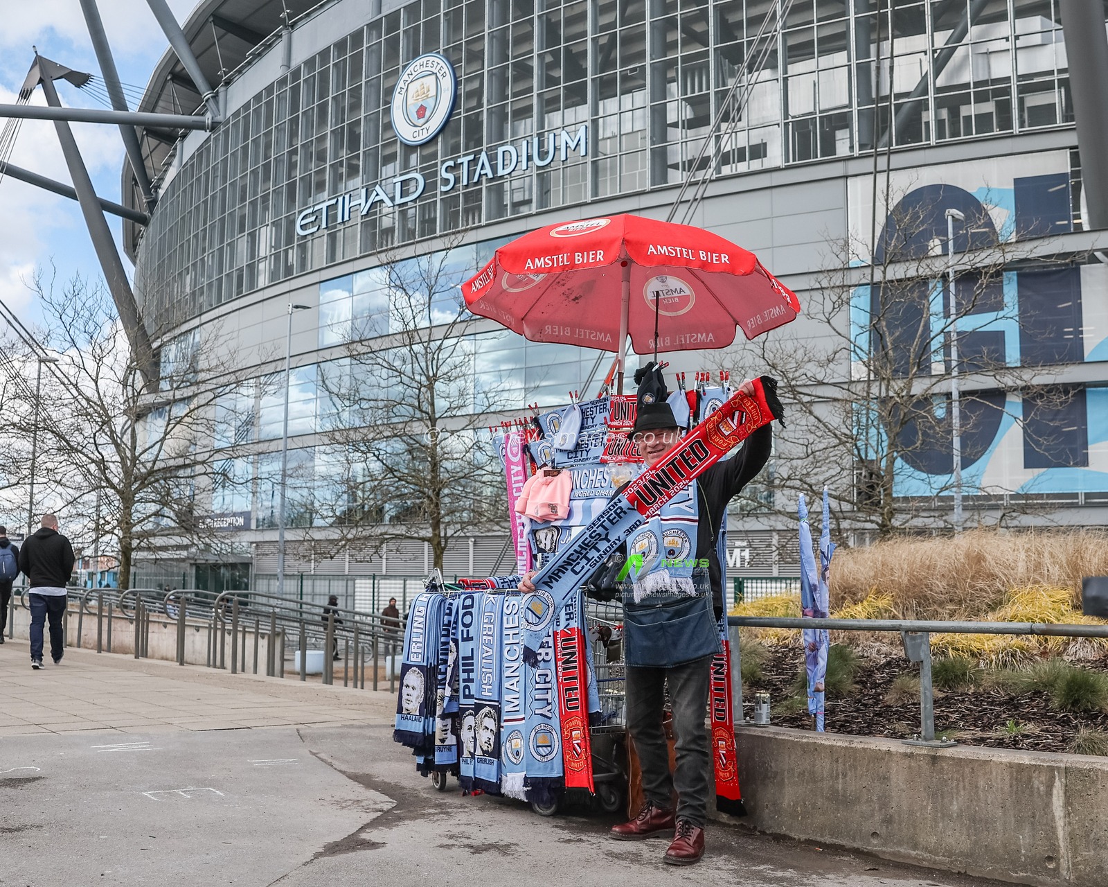A stall holder selling The 192nd Manchester Derby scarfs during the Premier League match Manchester City vs Manchester United at Etihad Stadium, Manchester, United Kingdom, 3rd March 2024

(Photo by Mark Cosgrove/News Images)