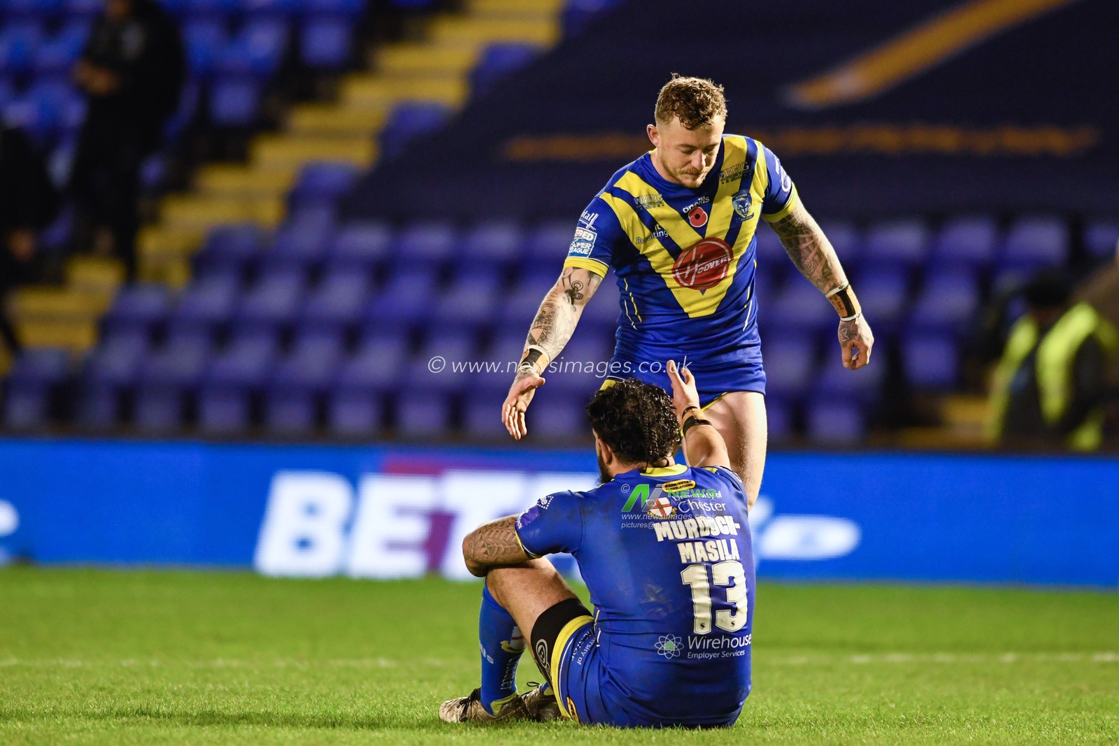 Josh Charnley #5 of Warrington Wolves looks to console Ben Murdoch-Masilla #13 of Warrington Wolves after their team lose at home 14-27