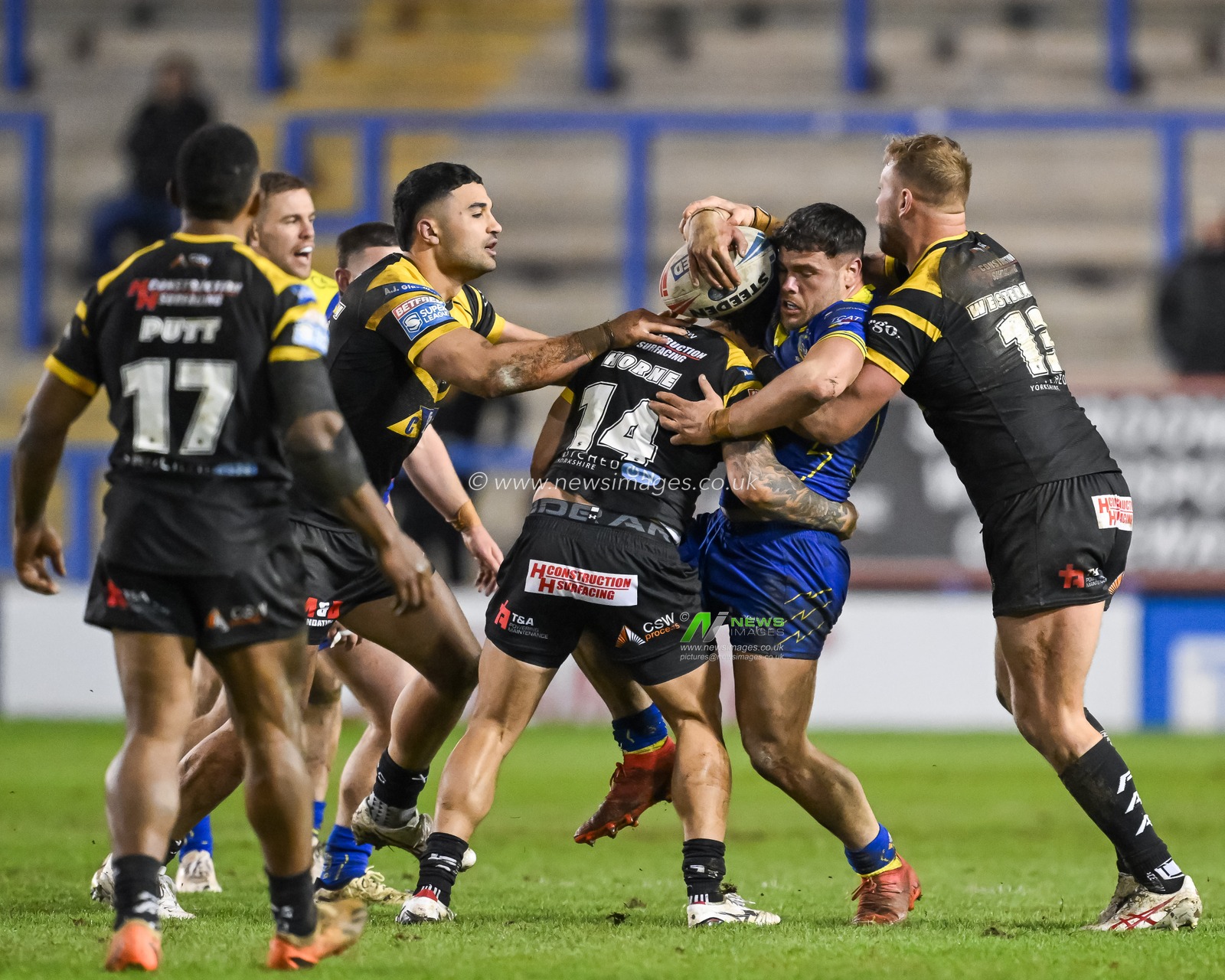 Joe Philbin of Warrington Wolves is tackled by Joe Westerman of Castleford Tigers and Liam Horne of Castleford Tigers during the Betfred Super League Round 3 match Warrington Wolves vs Castleford Tigers at Halliwell Jones Stadium, Warrington, United Kingdom, 1st March 2024

(Photo by Craig Thomas/News Images)
