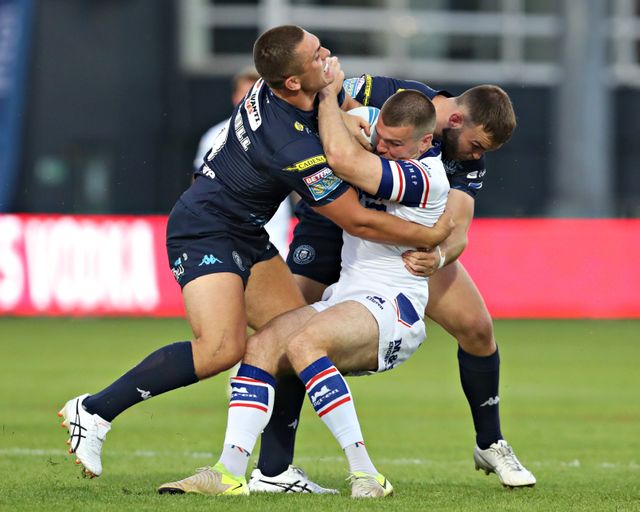 Kaide Ellis of Wigan Warriors and Brad O'Neill of Wigan Warriors tackle Max Jowitt of Wakefield Trinity during the Betfred Super League round 15 match Wakefield Trinity vs Wigan Warriors at DIY Kitchens Stadium, Wakefield, United Kingdom, 20th June 2025(Photo by Sam Eaden/News Images)