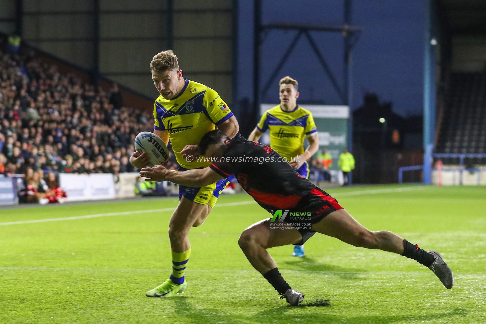George Williams of Warrington Wolves is tackled during the Betfred Challenge Cup match Widnes Vikings vs Warrington Wolves at DCBL Stadium, Widnes, United Kingdom, 15th March 2025

(Photo by Gareth Evans/News Images)