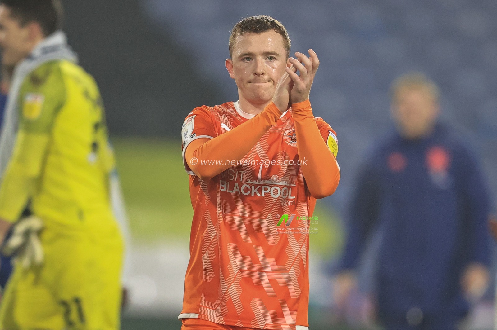 Shayne Lavery #19 of Blackpool applauds the traveling fans