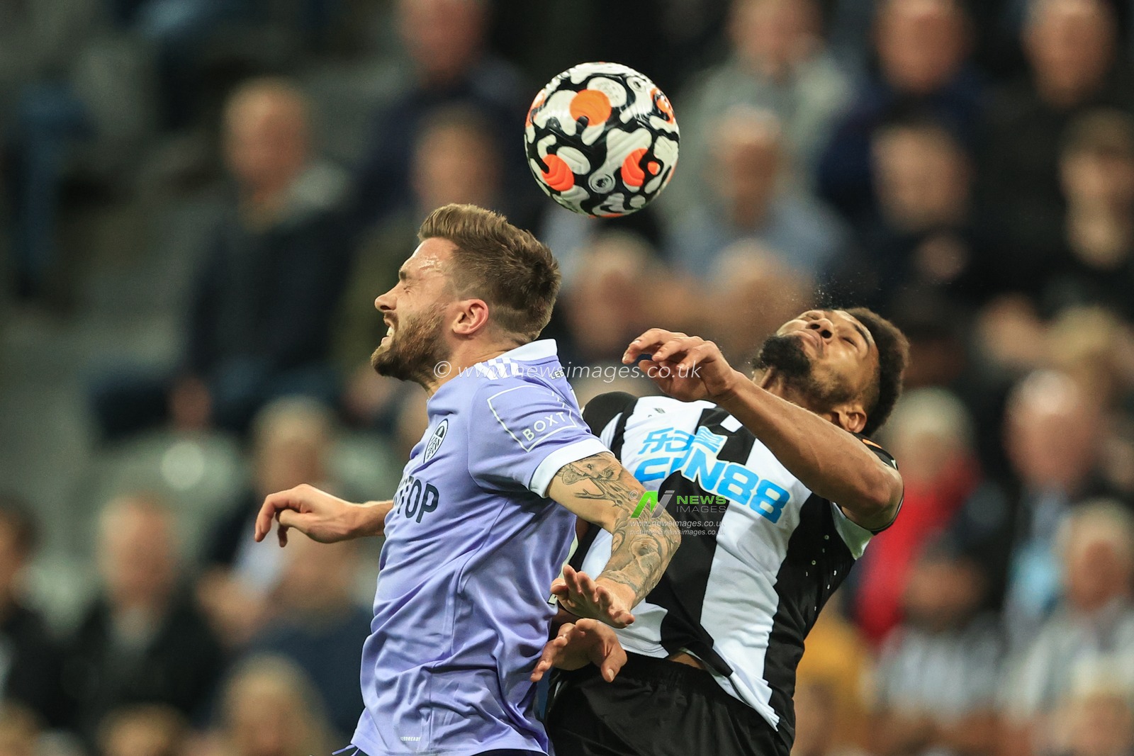 Stuart Dallas #15 of Leeds United and Joelinton #7 of Newcastle United battle for the ball