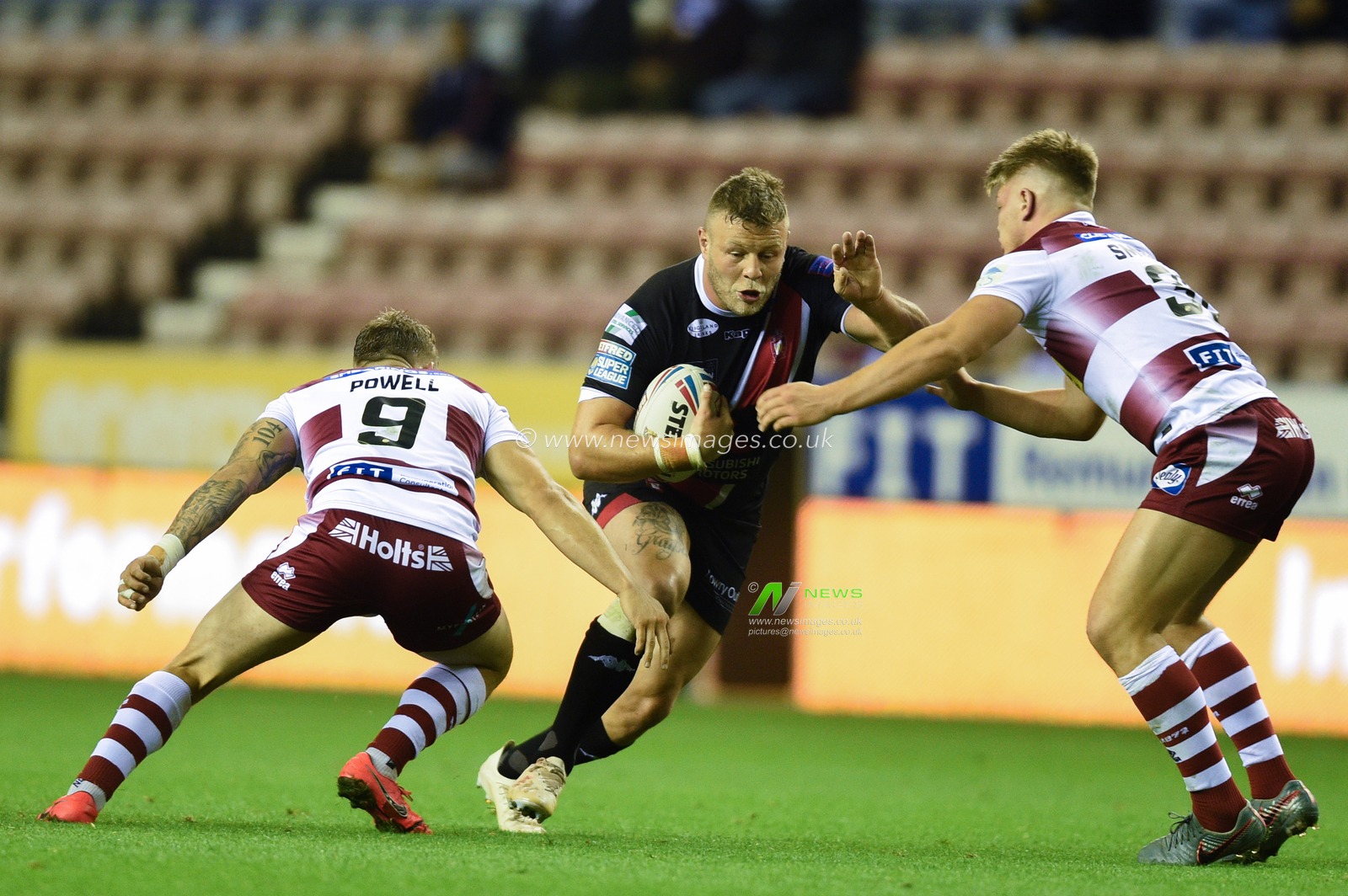 20th September 2019 , DW Stadium, Wigan, England;  Betfred Super League, Round  Playoffs, Wigan Warriors vs Salford Red Devils ; Josh Jones (11) of Salford Red Devils is tackled by Morgan Smithies (38) of Wigan Warriors and Sam Powell (9) of Wigan Warriors 


Credit: Richard Long/News Images