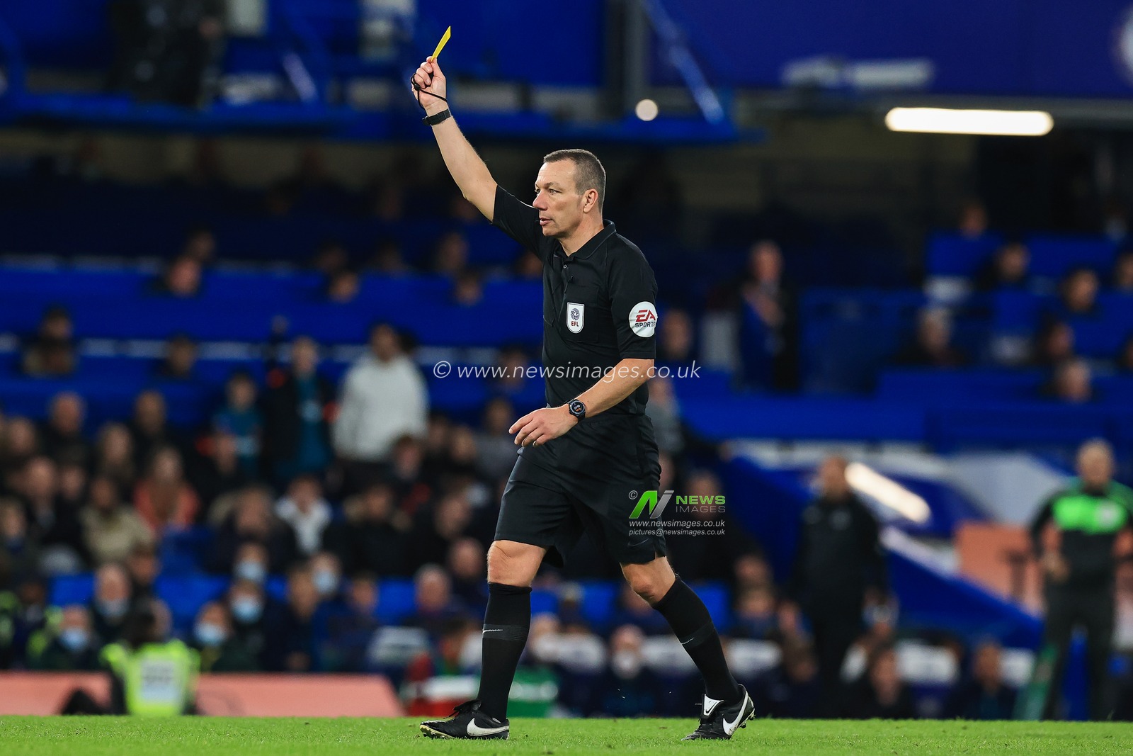 Referee Kevin Friend gives a yellow card to Fraser Forster #44 of Southampton