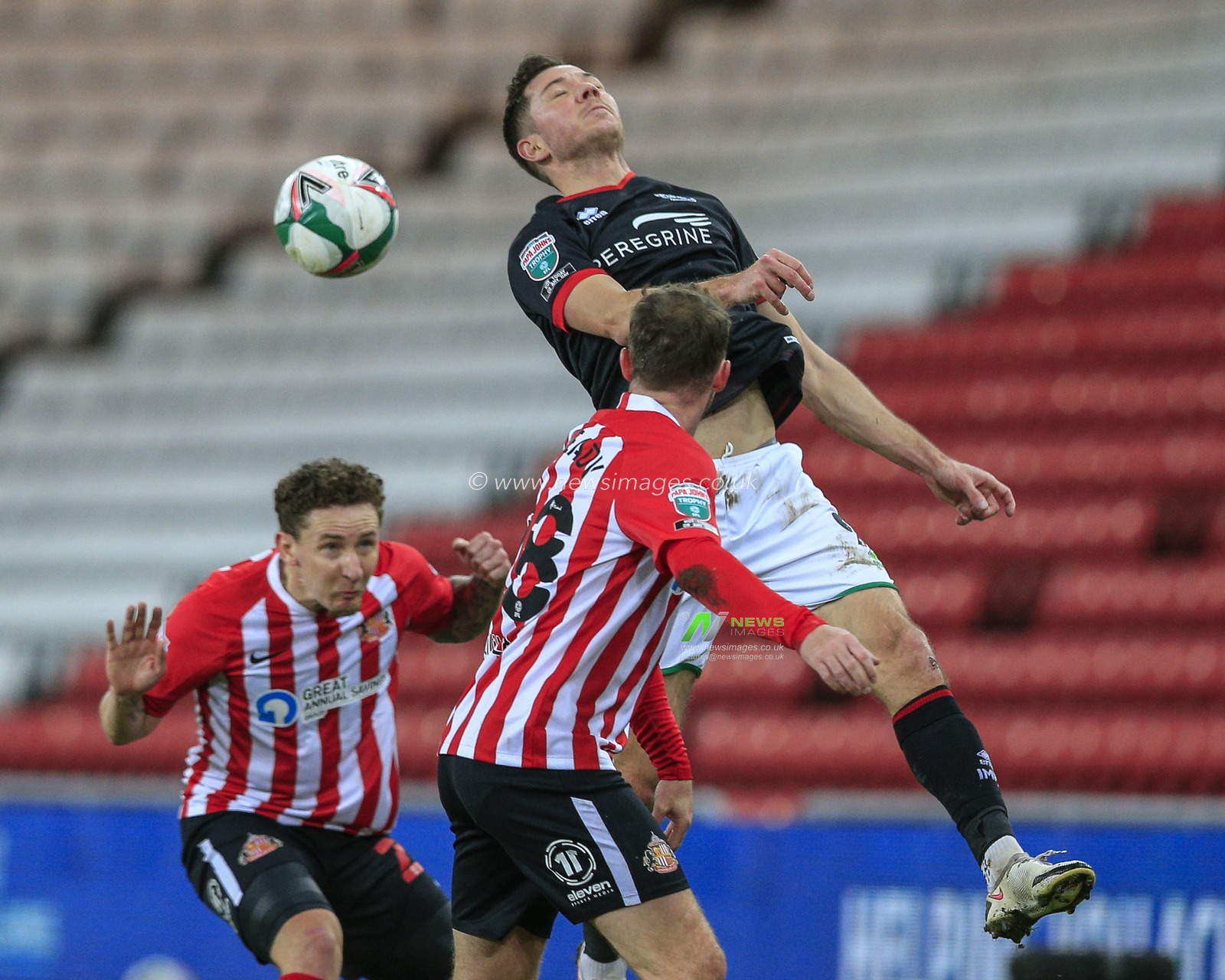 Tom Hopper #9 of Lincoln City in an aerial challenge with Callum McFadzean #25 of Sunderland and Aiden McGeady #28 of Sunderland
