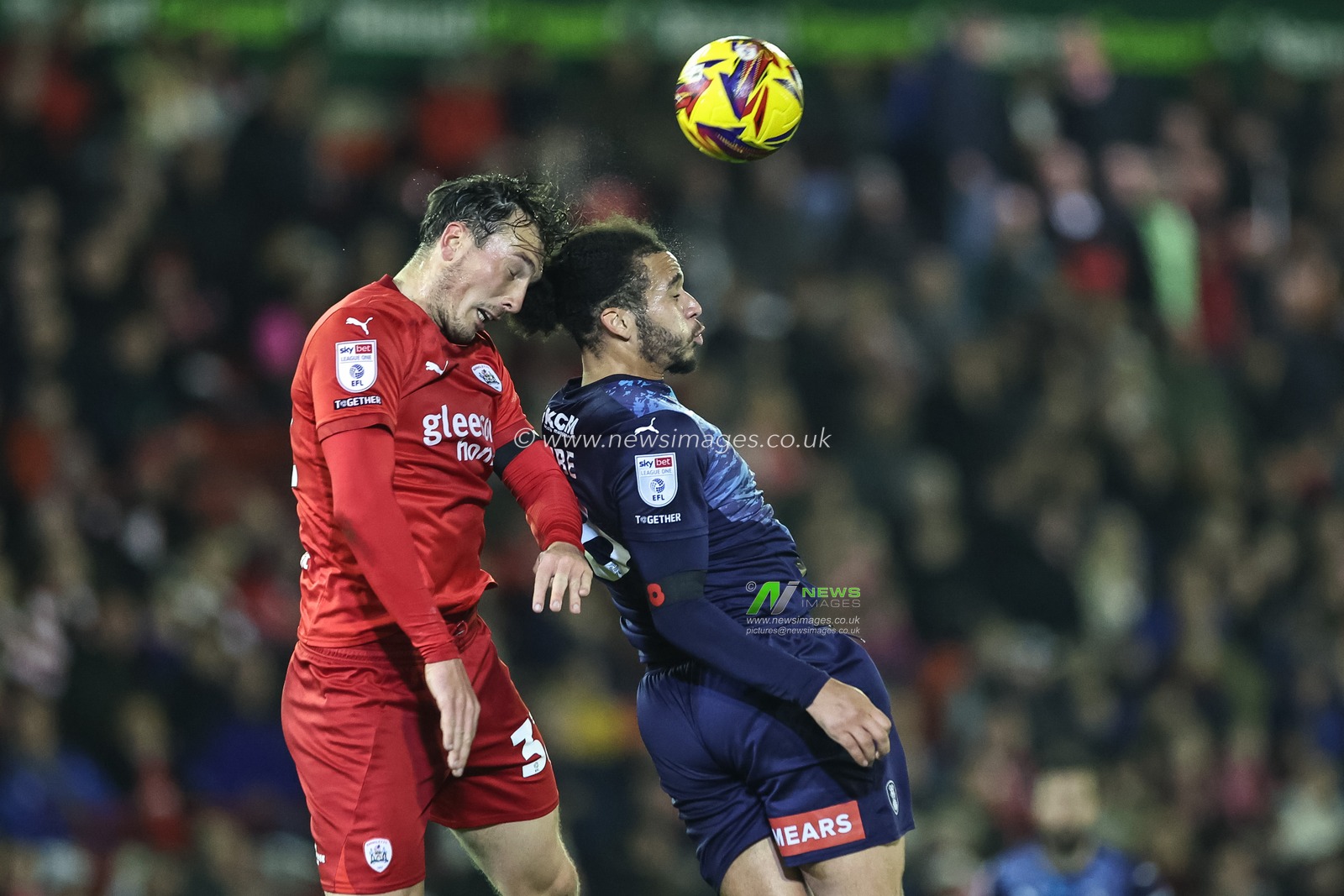 Josh Earl of Barnsley heads the ball clear of his defensive area from Sam Nombe of Rotherham United during the Sky Bet League 1 match Barnsley vs Rotherham United at Oakwell, Barnsley, United Kingdom, 8th November 2024

(Photo by Mark Cosgrove/News Images)
