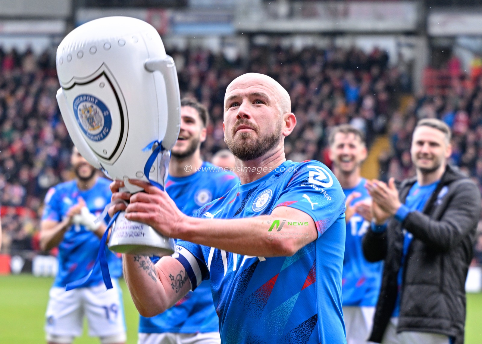 Paddy Madden of Stockport County lifts a fans inflatable trophy, during the Sky Bet League 2 match Wrexham vs Stockport County at SToK Cae Ras, Wrexham, United Kingdom, 27th April 2024

(Photo by Cody Froggatt/News Images)