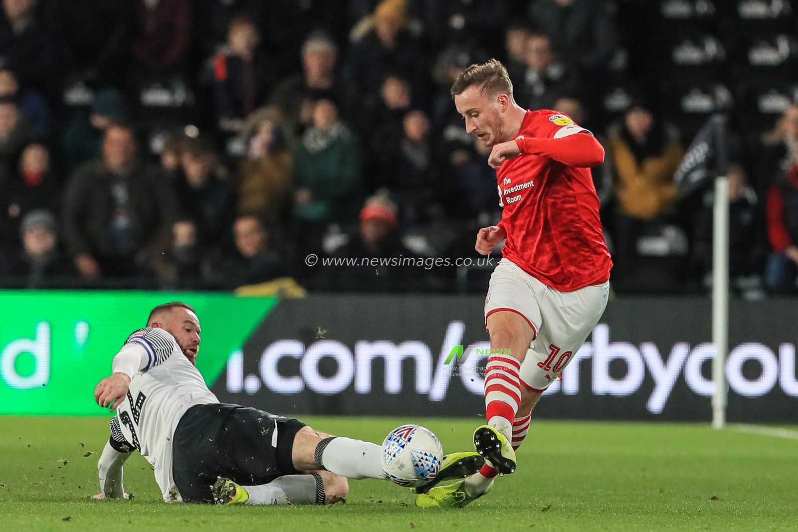 2nd January 2020, Pride Park Stadium, Derby, England; Sky Bet Championship, Derby County v Barnsley : Mike Bahre (10) of Barnsley manages to keep the ball as Wayne Rooney (32) of Derby County slides in 

Credit: Mark Cosgrove/News Images