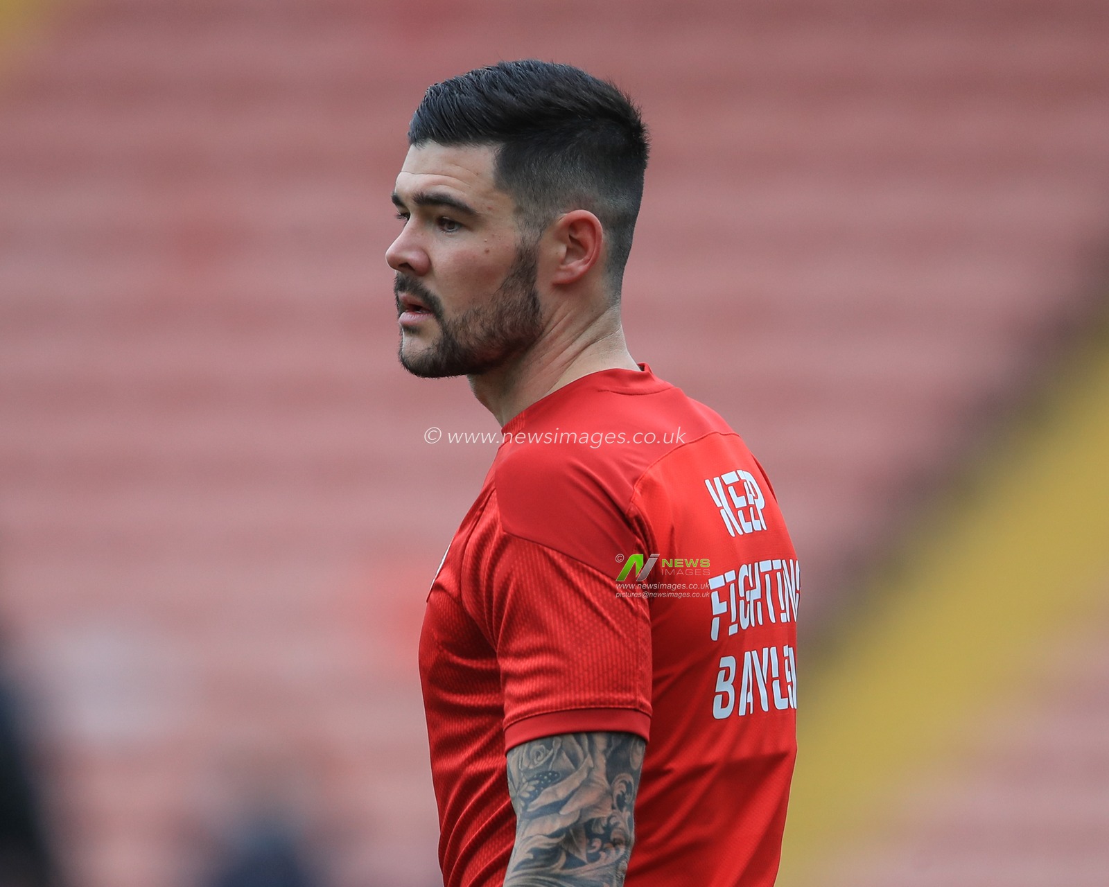 Alex Mowatt #27 of Barnsley wearing a â€˜Keep up the fight Bayleyâ€ T-shirt