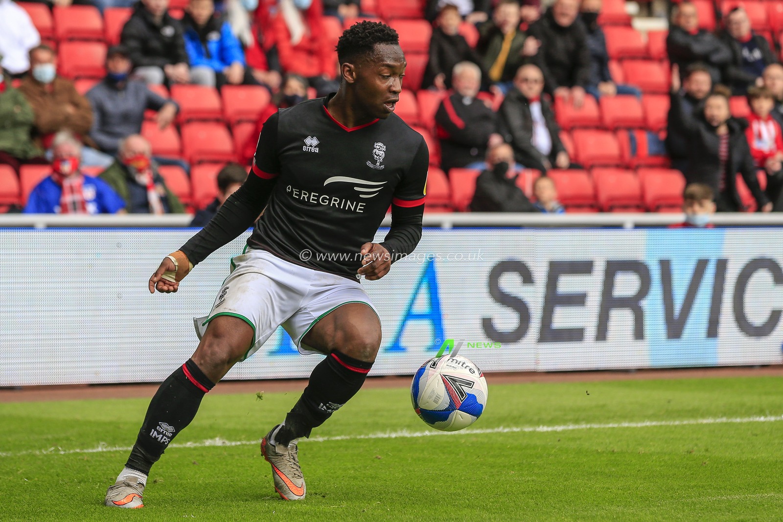 Tayo Edun #7 of Lincoln City in possession of the ball