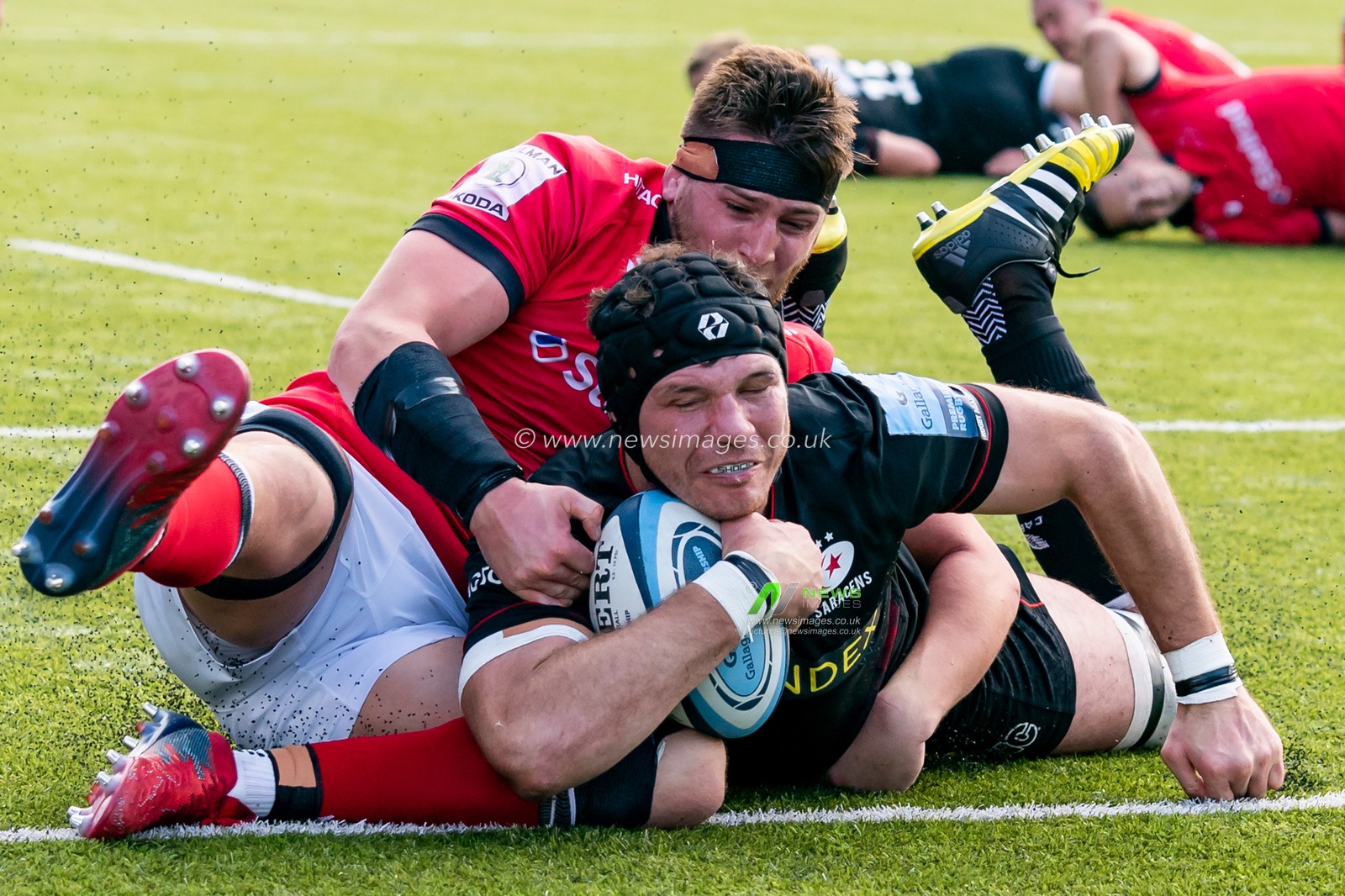 Sean Robinson #5 of Newcastle Falcons manages to stop  Tim Swinson #5 of Saracens from grounding the ball. No try