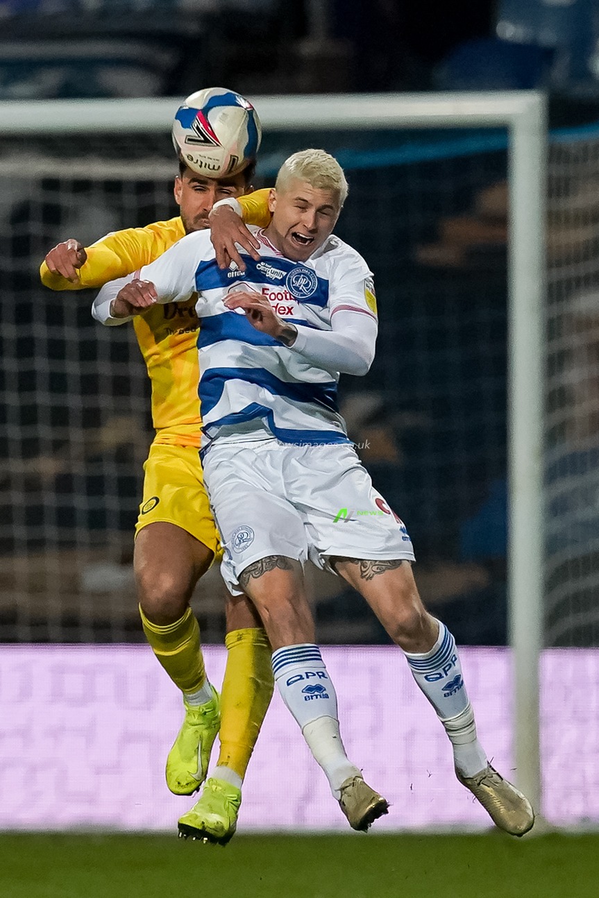 Ryan Tafazolli #6 of Wycombe Wanderers battles with Lyndon Dykes #9 of Queens Park Rangers