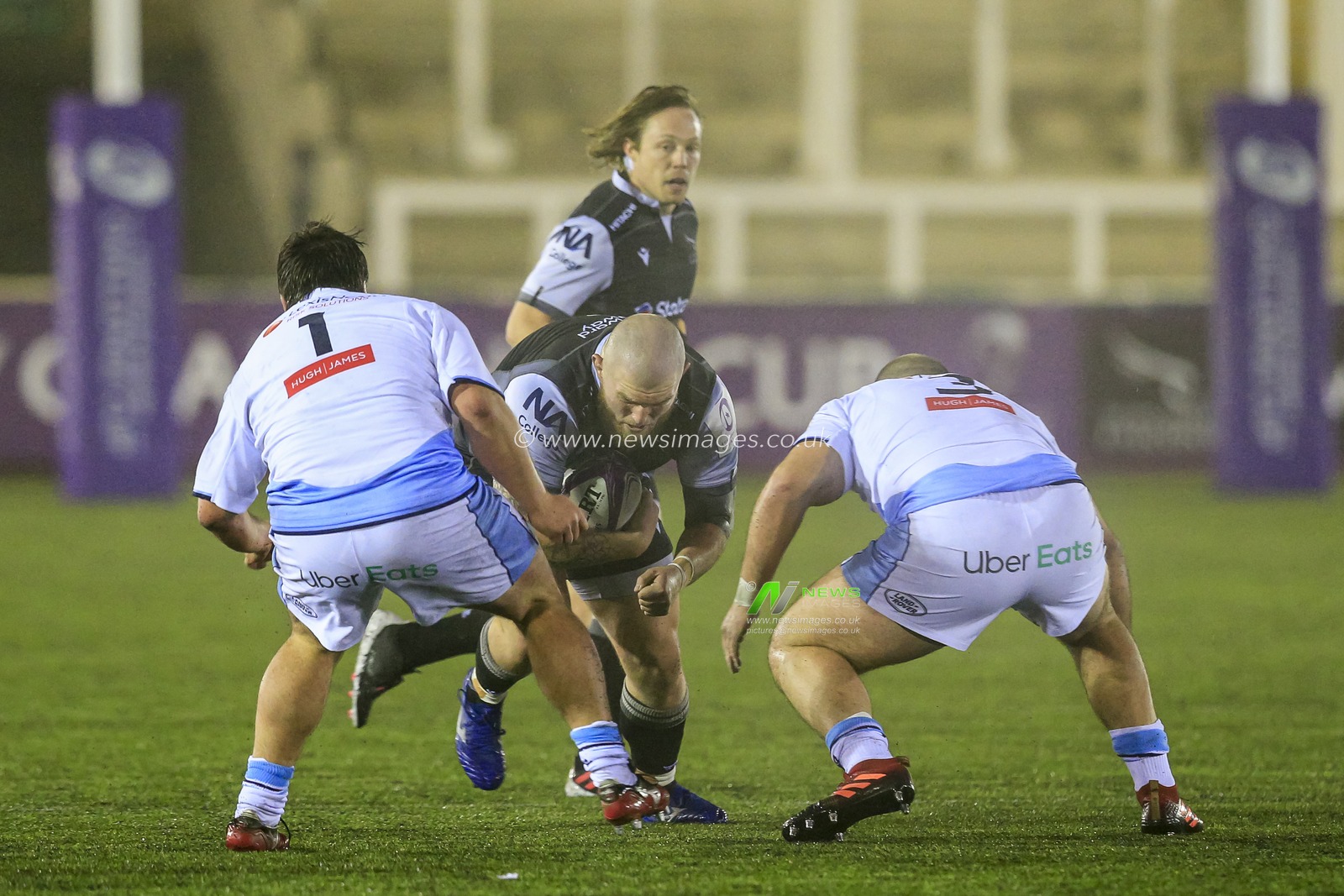 Adam Brocklebank of Newcastle Falcons tries to get through the gap between Brad Thyer of Cardiff Blues and Dillon Lewis of Cardiff Blues