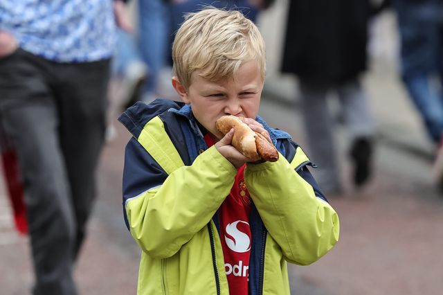 A young Manchester United fan grabs a bite of a hotdog during the Premier League match Manchester United vs Liverpool at Old Trafford, Manchester, United Kingdom on 03 May 2026

(Photo by Mark Cosgrove/News Images)