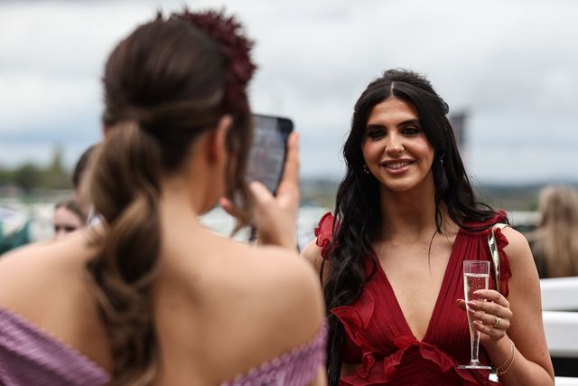 A racegoer has her picture take by a friend  during the Randox Grand National Day 2024 at Aintree Racecourse, Liverpool, United Kingdom, 13th April 2024

(Photo by Mark Cosgrove/News Images)
