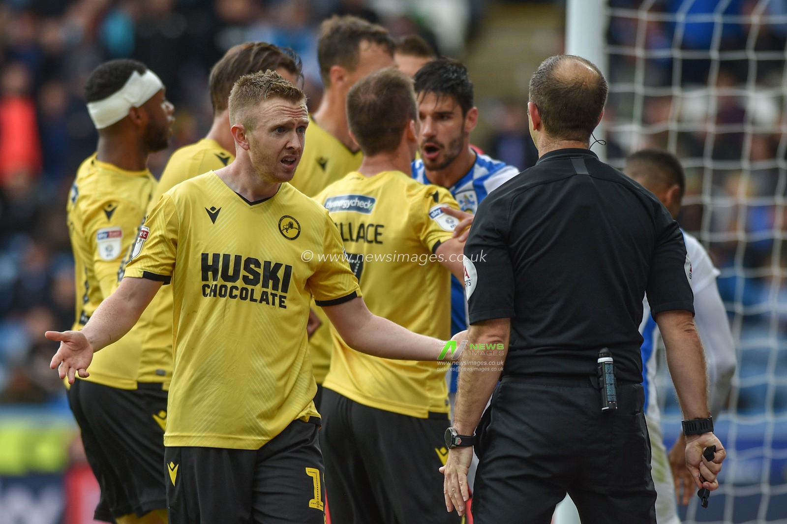 28th September 2019, John Smith's Stadium, Huddersfield, England; Sky Bet Championship, Huddersfield Town v Millwall : Shane Ferguson (11) of Millwall pleads with referee Jeremy Simpson after receiving his second yellow card.

Credit: Dean Williams/News Images