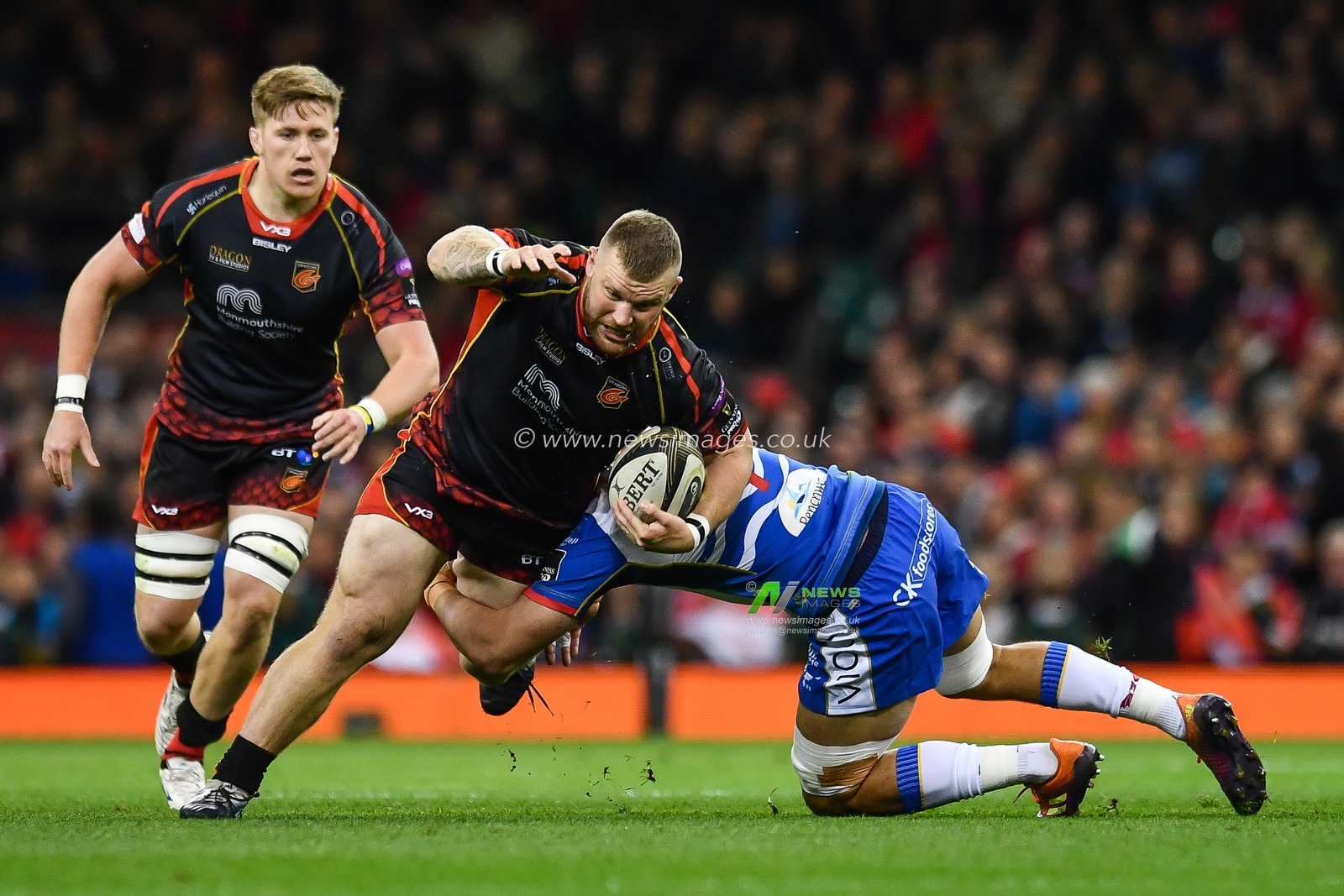 27th April 2019 , Principality Stadium , Cardiff, Wales ; Guinness pro 14â€™s, Round 21, Dragons vs Scarlets ; Lloyd Fairbrother of Dragons is tackled by Josh Macleod of Scarlets

Credit:  Craig Thomas/News Images