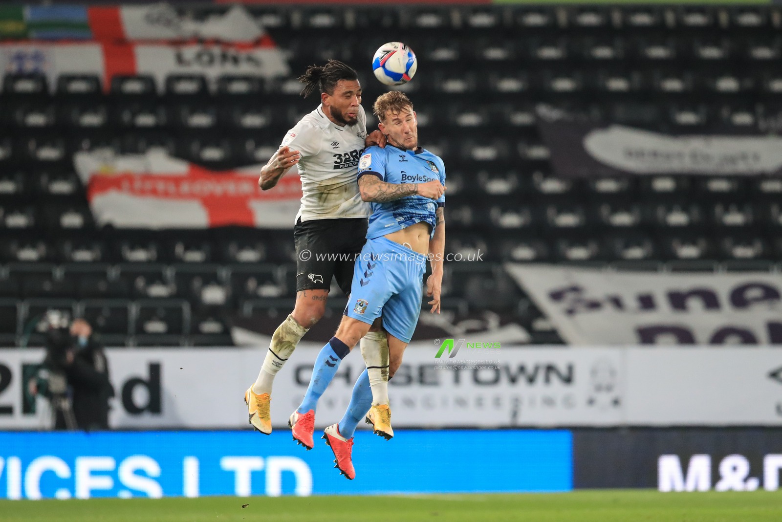 Colin Kazim-Richards #13 of Derby County wins the high ball from Kyle McFadzean #5 of Coventry City