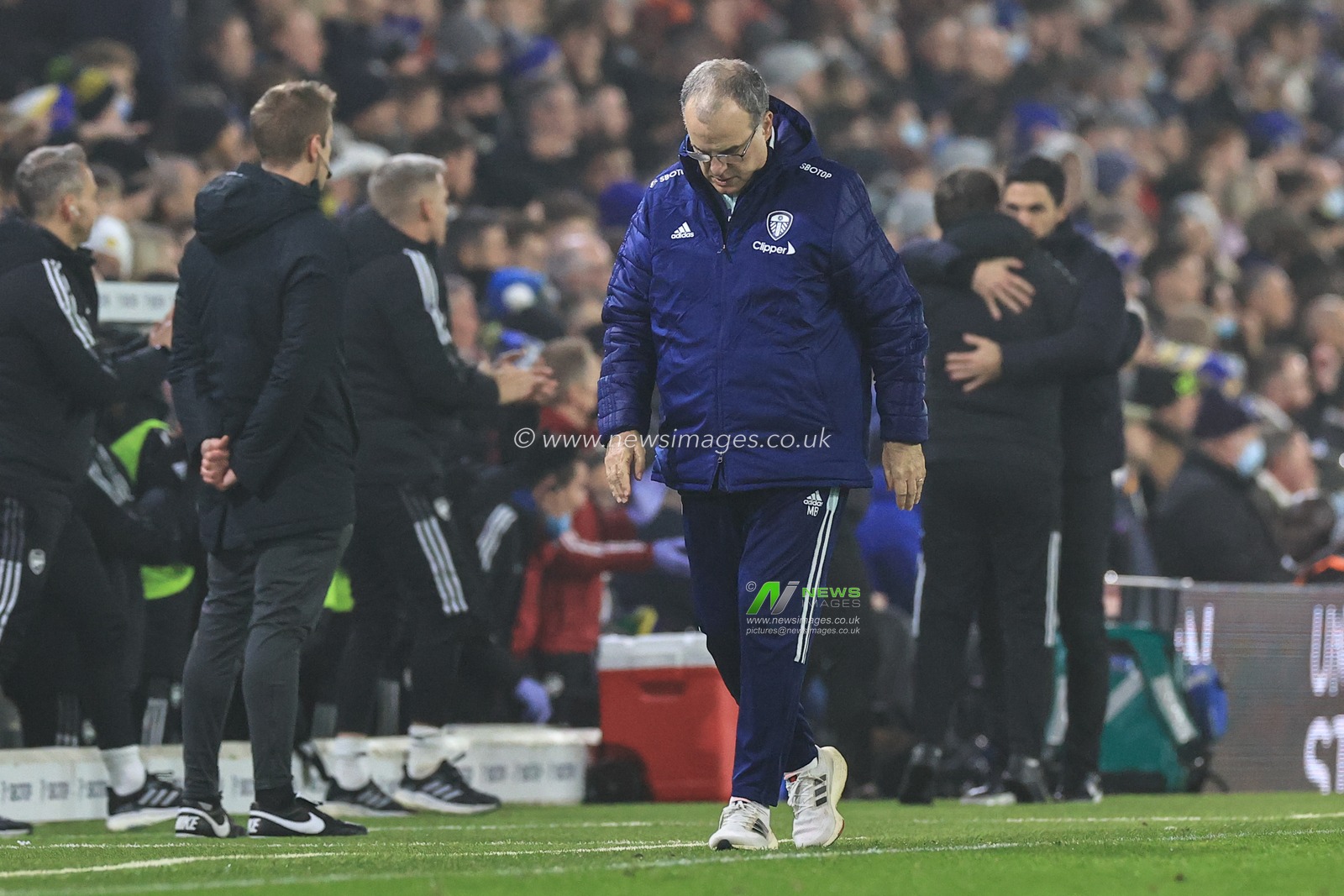 A dejected Marcelo Bielsa manager of Leeds United walks away from Mikel Arteta manager of Arsenal who is celebrating Bukayo Saka #7 of Arsenalâ€™s goal to make it 0-3