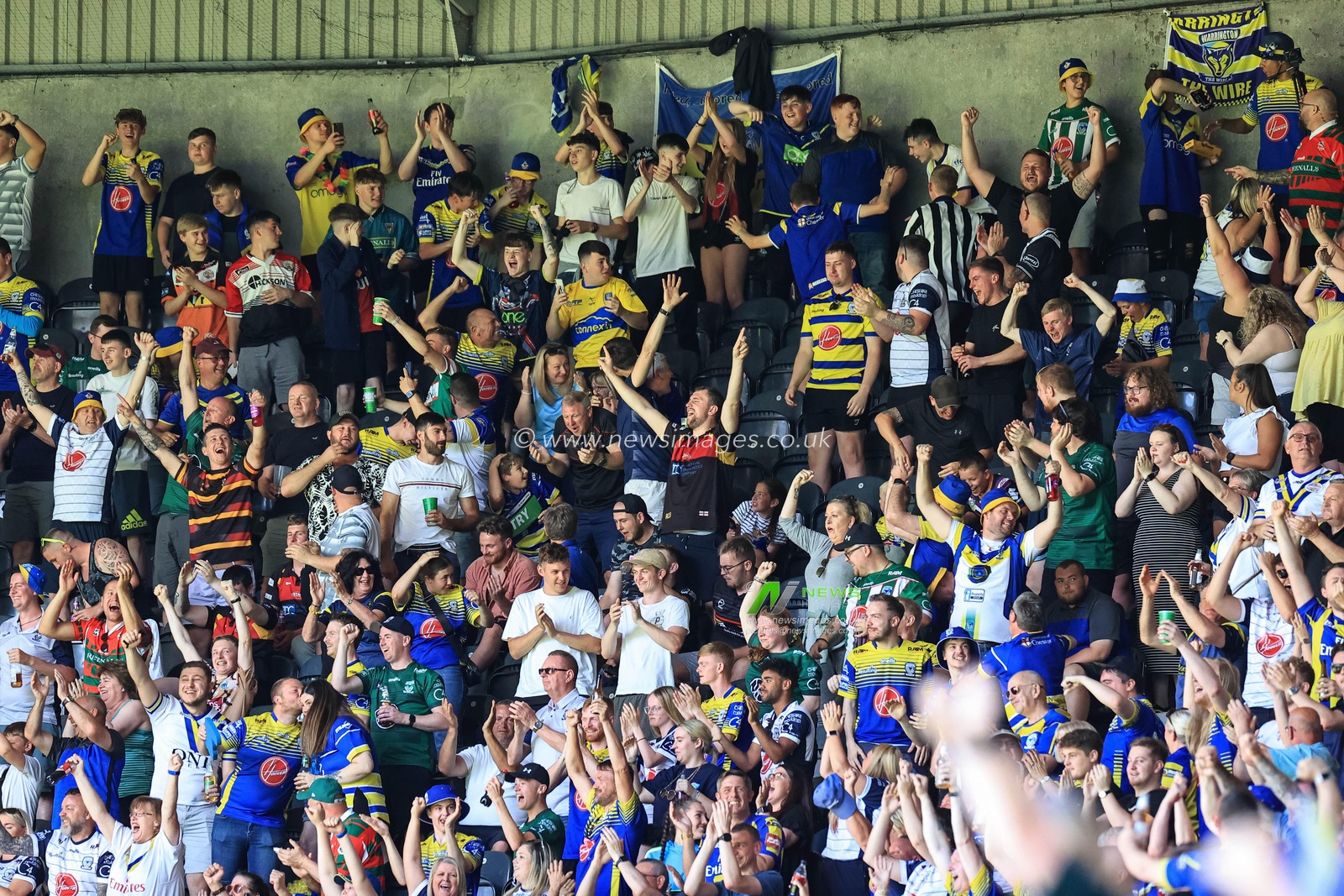 Warrington fans celebrate Josh Thewlis #22 of Warrington Wolves making a 70 yard solo dash to go over for a try