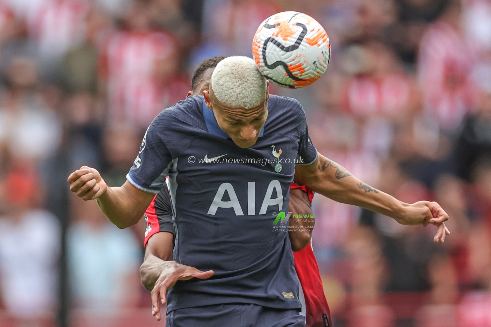 Richarlison Tottenham Hotspur wins the ball under pressure from Ethan Pinnock of Brentford during the Premier League match Brentford vs Tottenham Hotspur at Brentford Community Stadium, London, United Kingdom, 13th August 2023

(Photo by Mark Cosgrove/News Images)